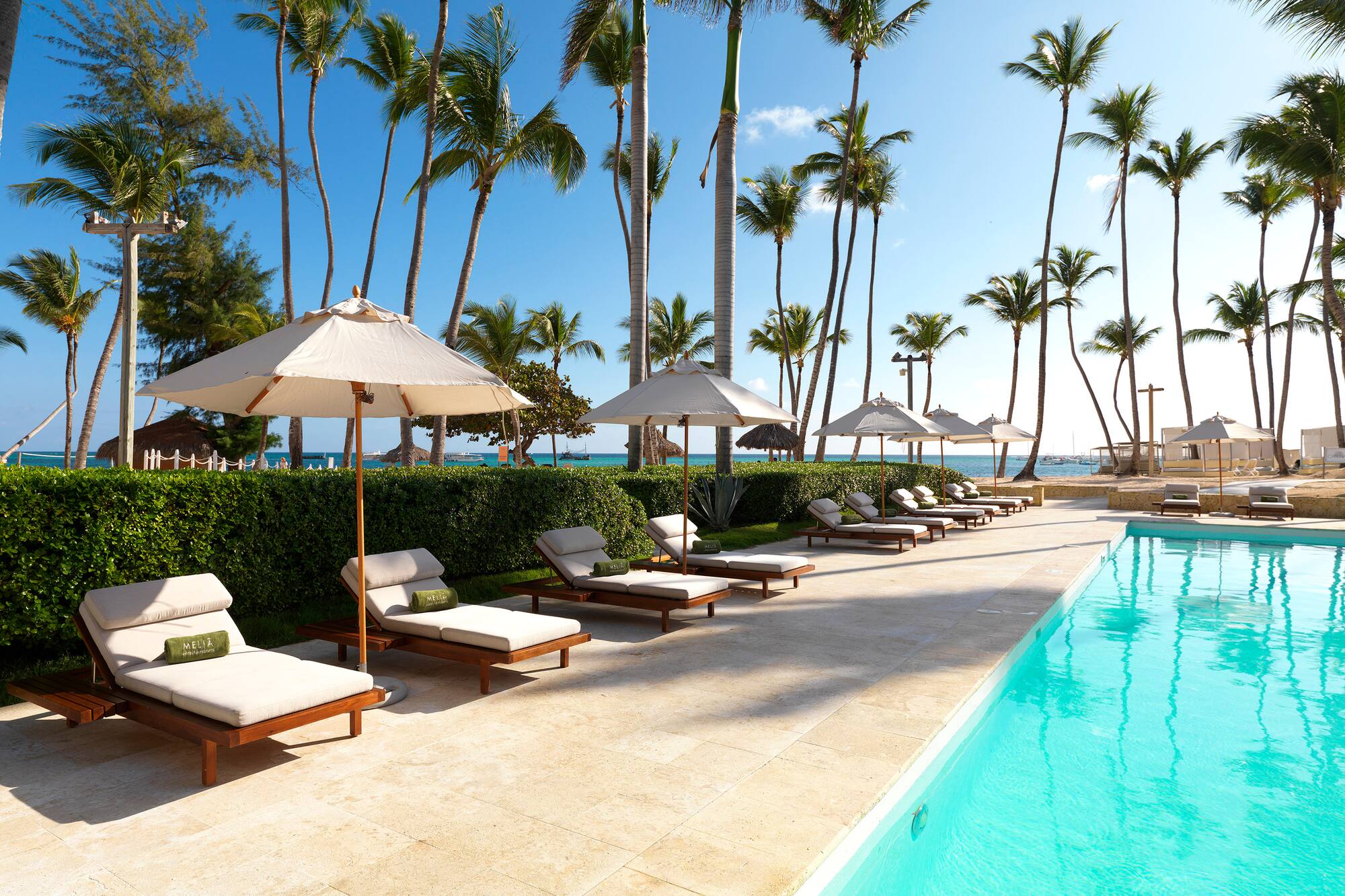 a pool with lounge chairs and umbrellas