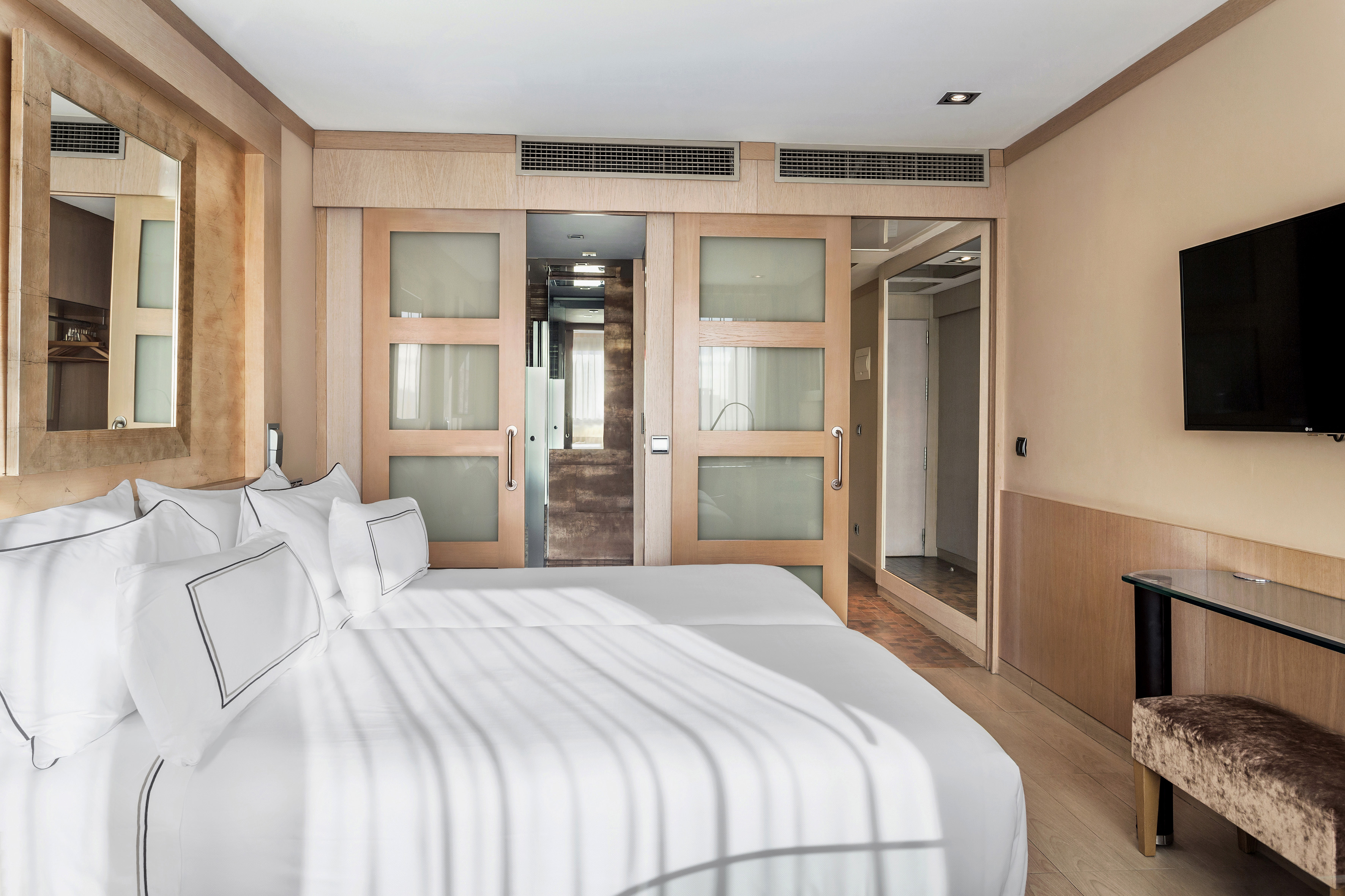 a room with two beds and a door