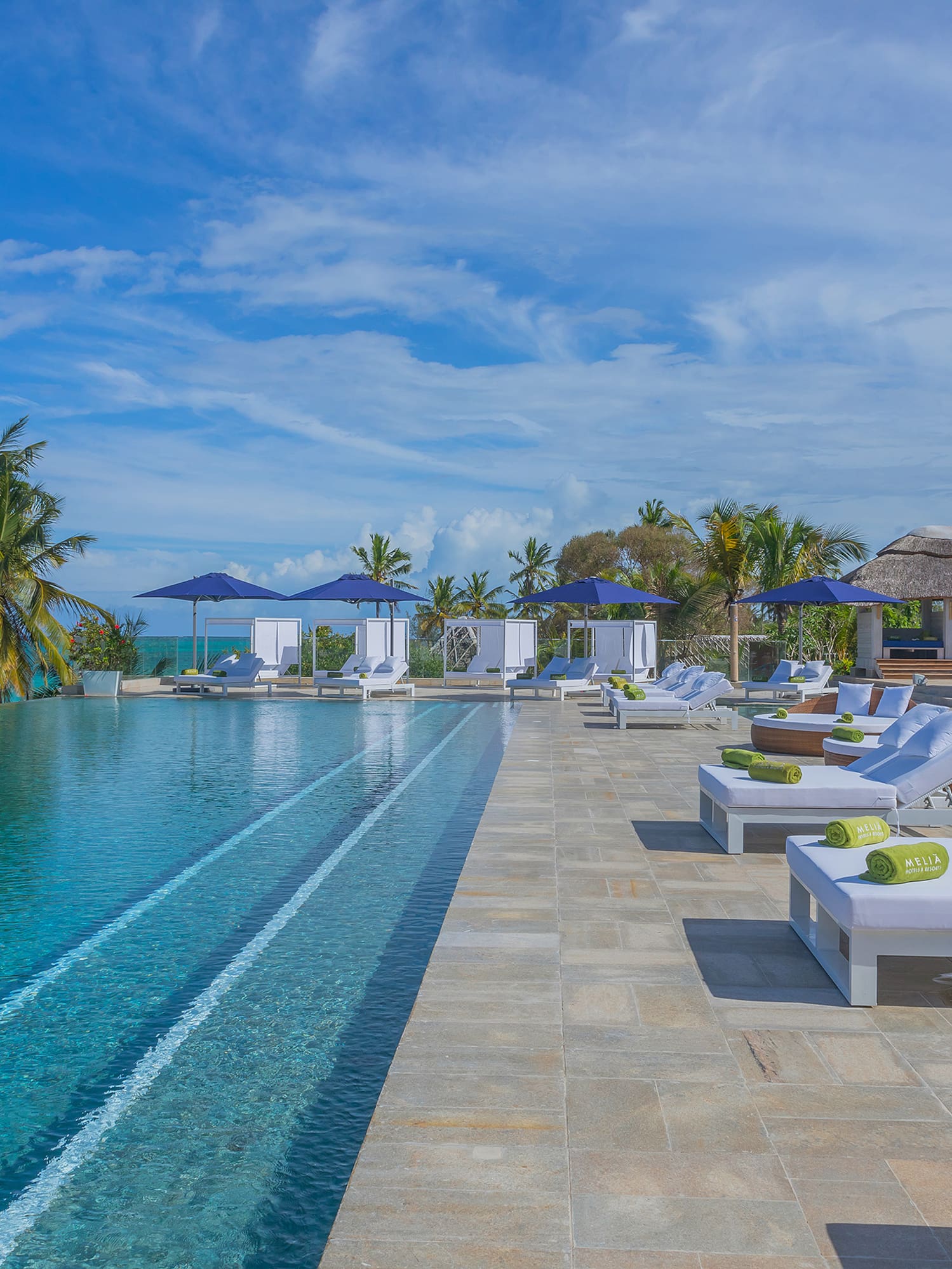 a pool with lounge chairs and umbrellas