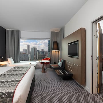 a room with a bed and a television