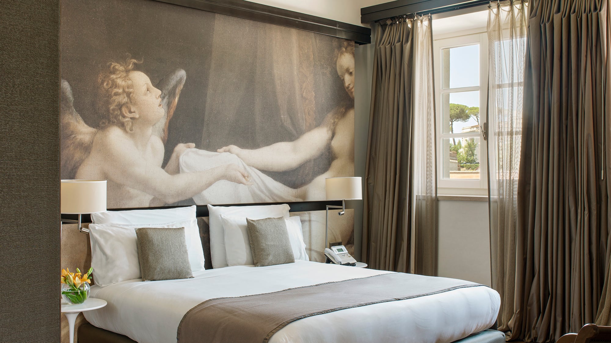 a bedroom with a large painting on the wall