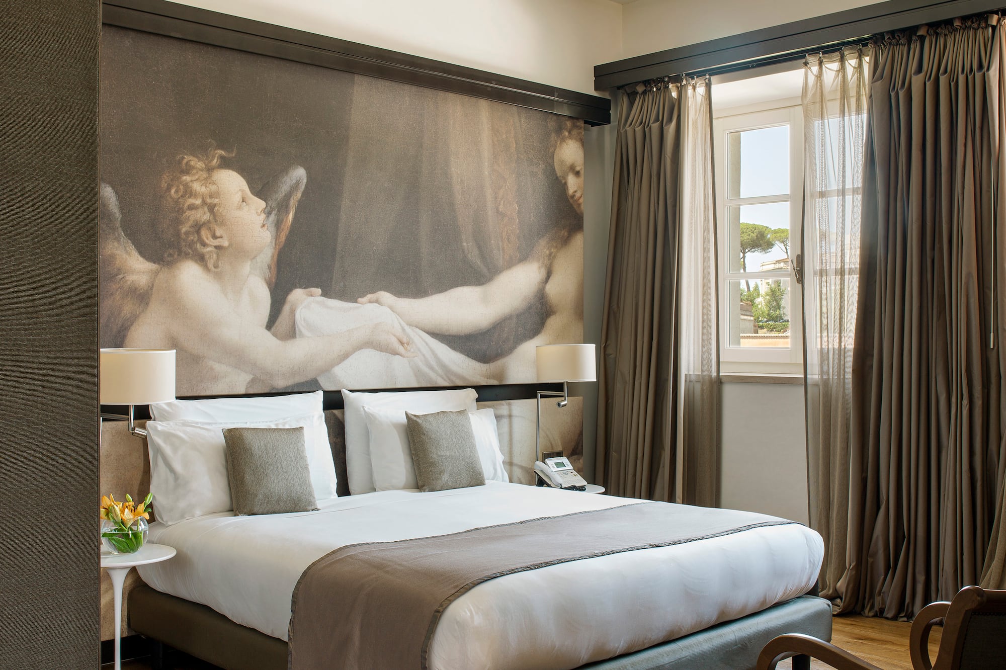 a bedroom with a large painting on the wall