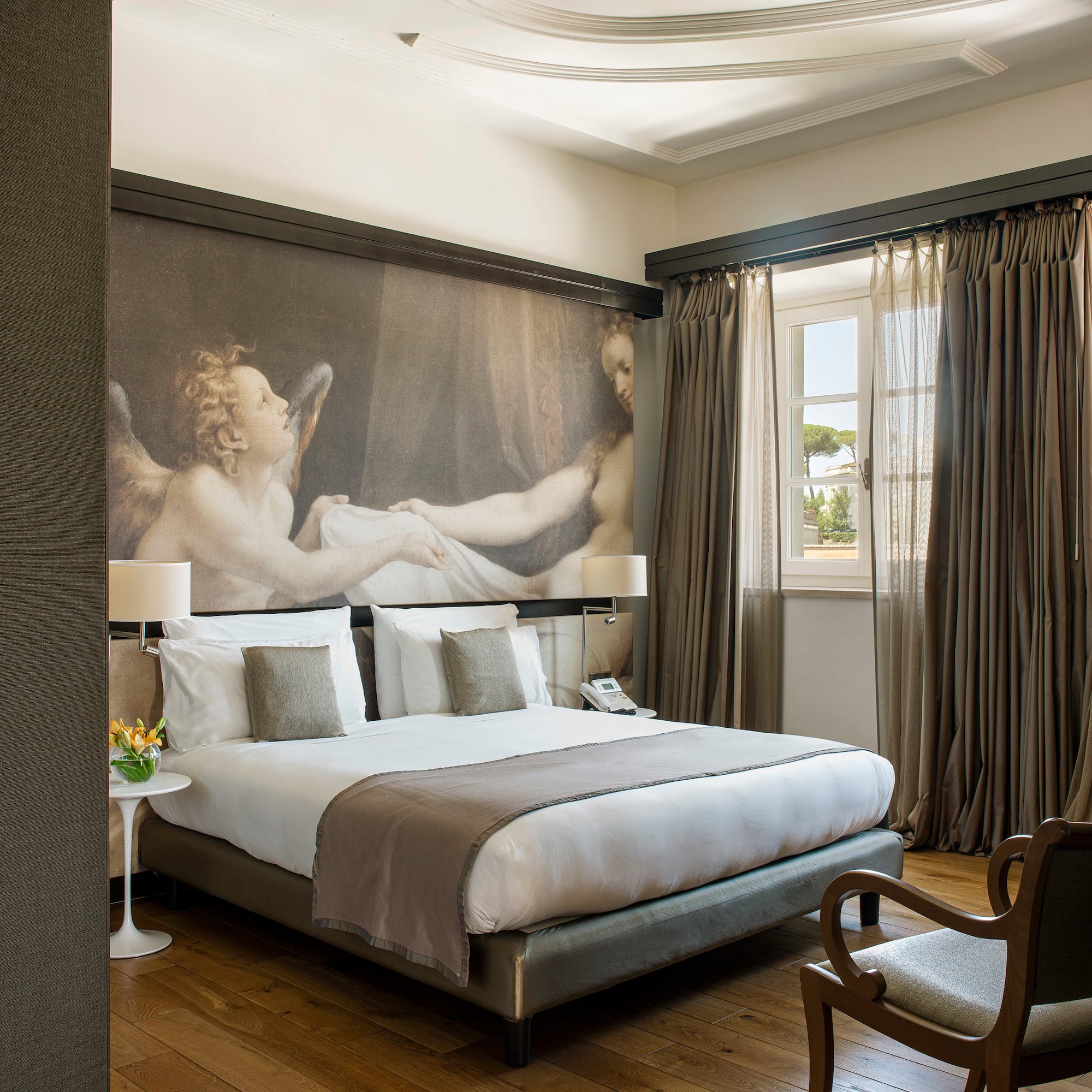 a bedroom with a large painting on the wall