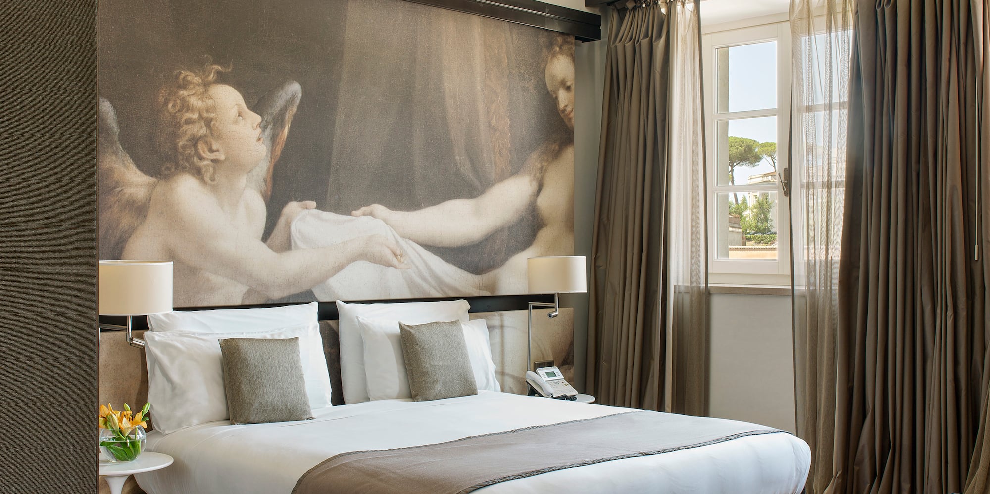 a bedroom with a large painting on the wall