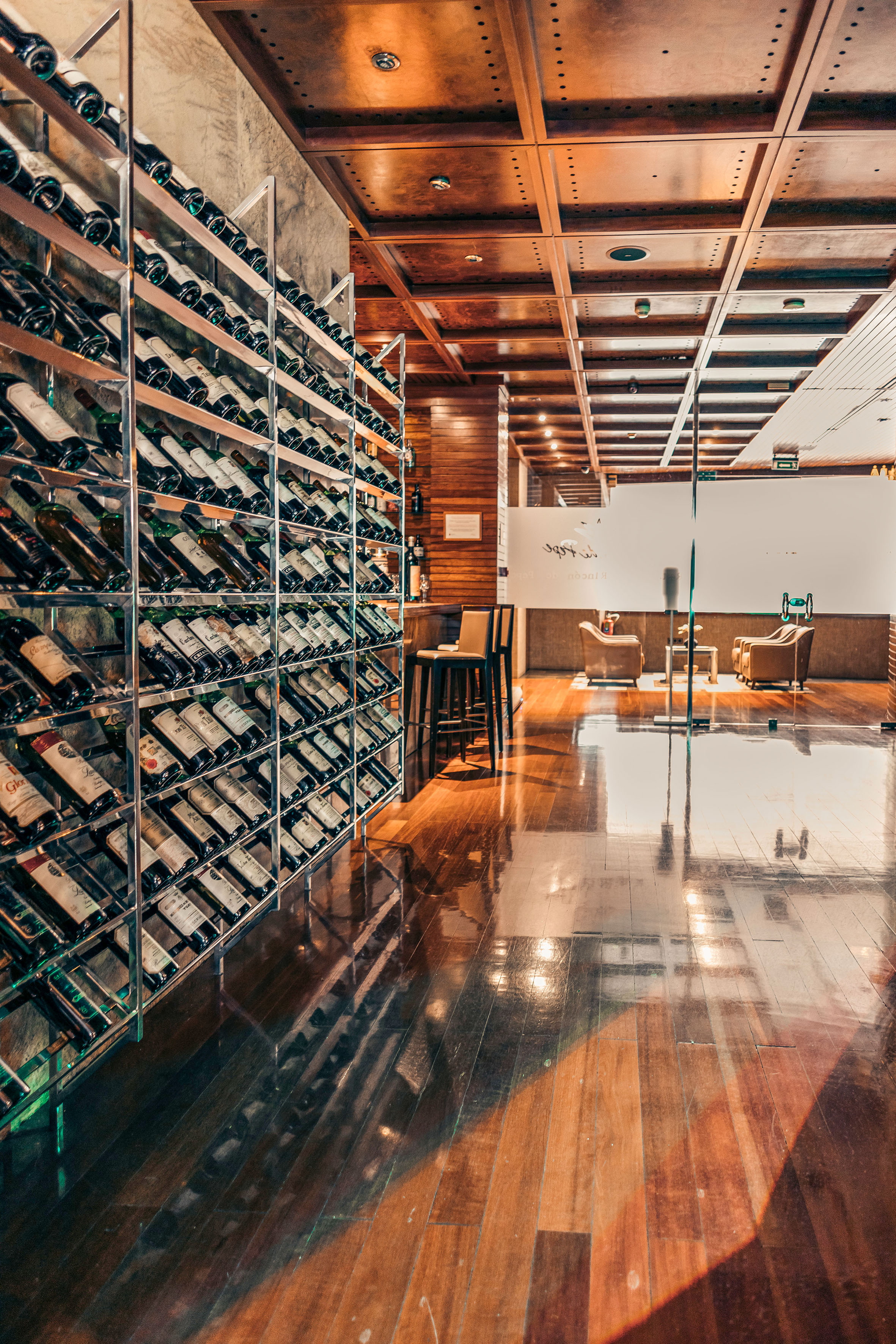 Tall wine rack filled with bottles in a modern wine bar interior with wood floor. - Rincón de Pepe Restaurant, Local cuisine - Hotel Murcia Rincón de Pepe Affiliated by Meliá, Murcia