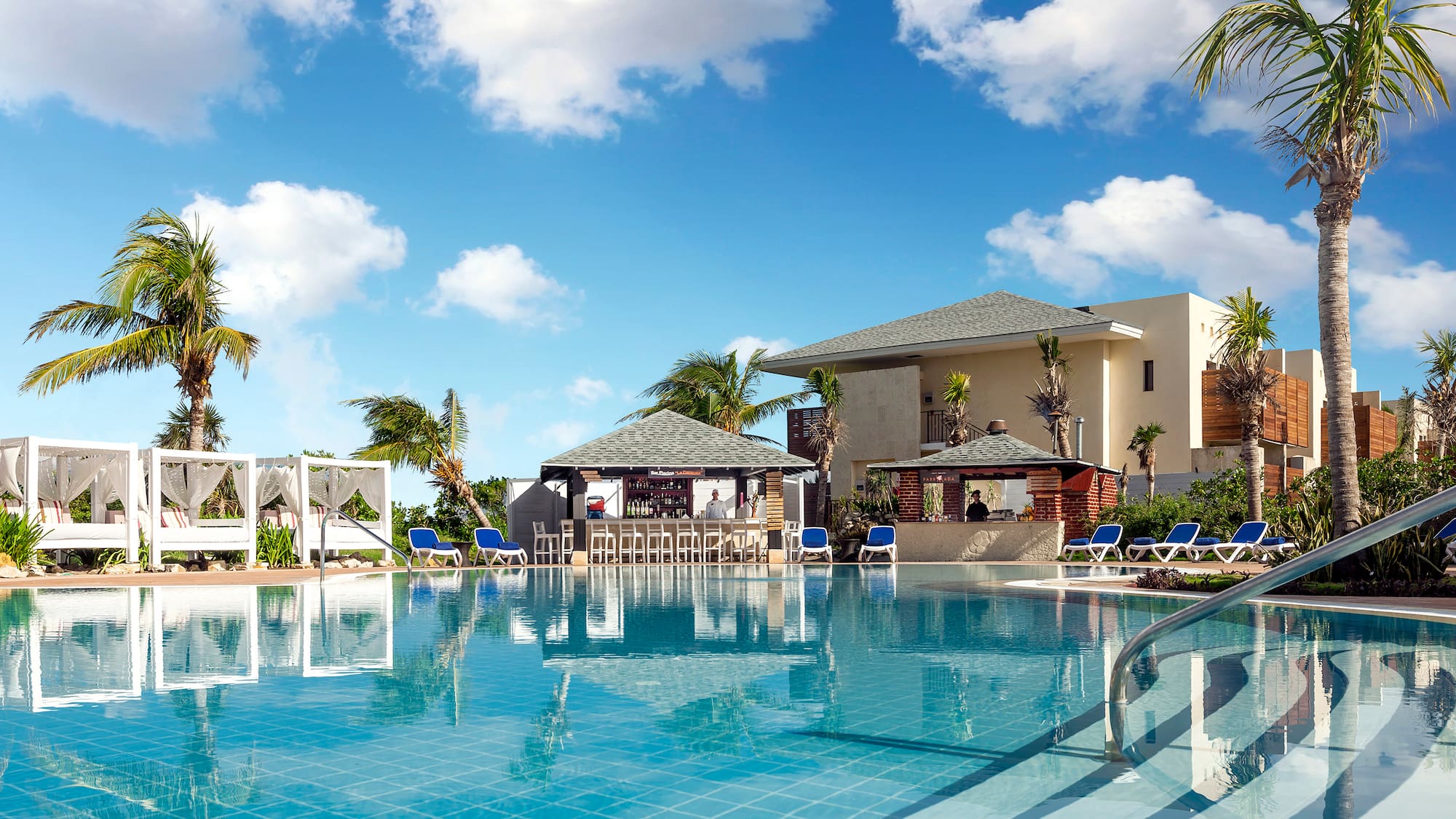 a pool with chairs and a bar