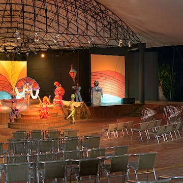 a stage with chairs and a stage with people on it