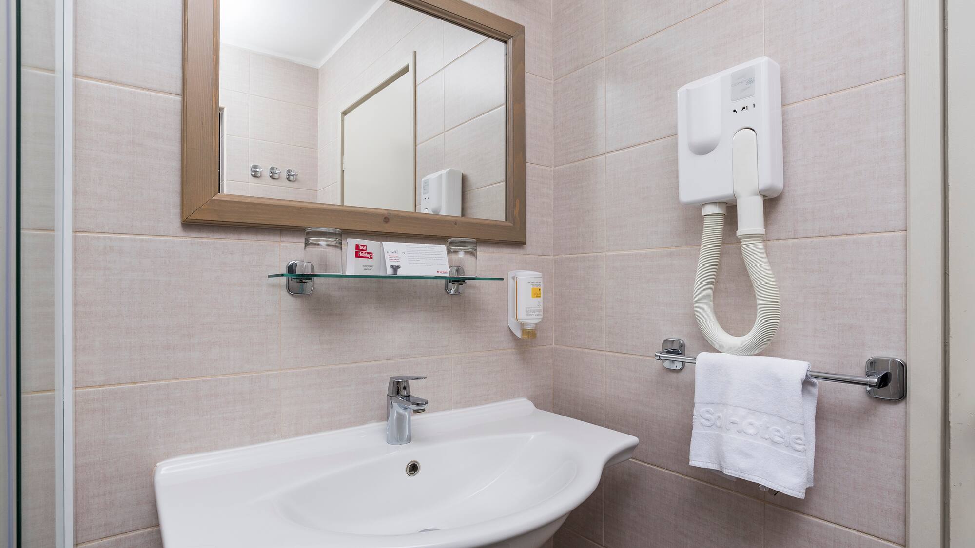 a bathroom with a mirror and sink