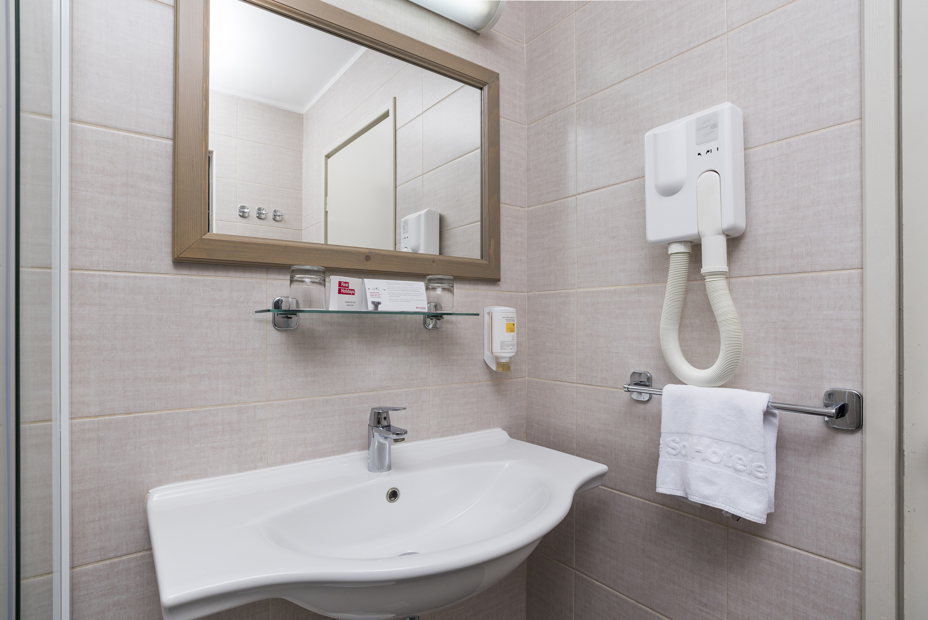 a bathroom with a mirror and sink