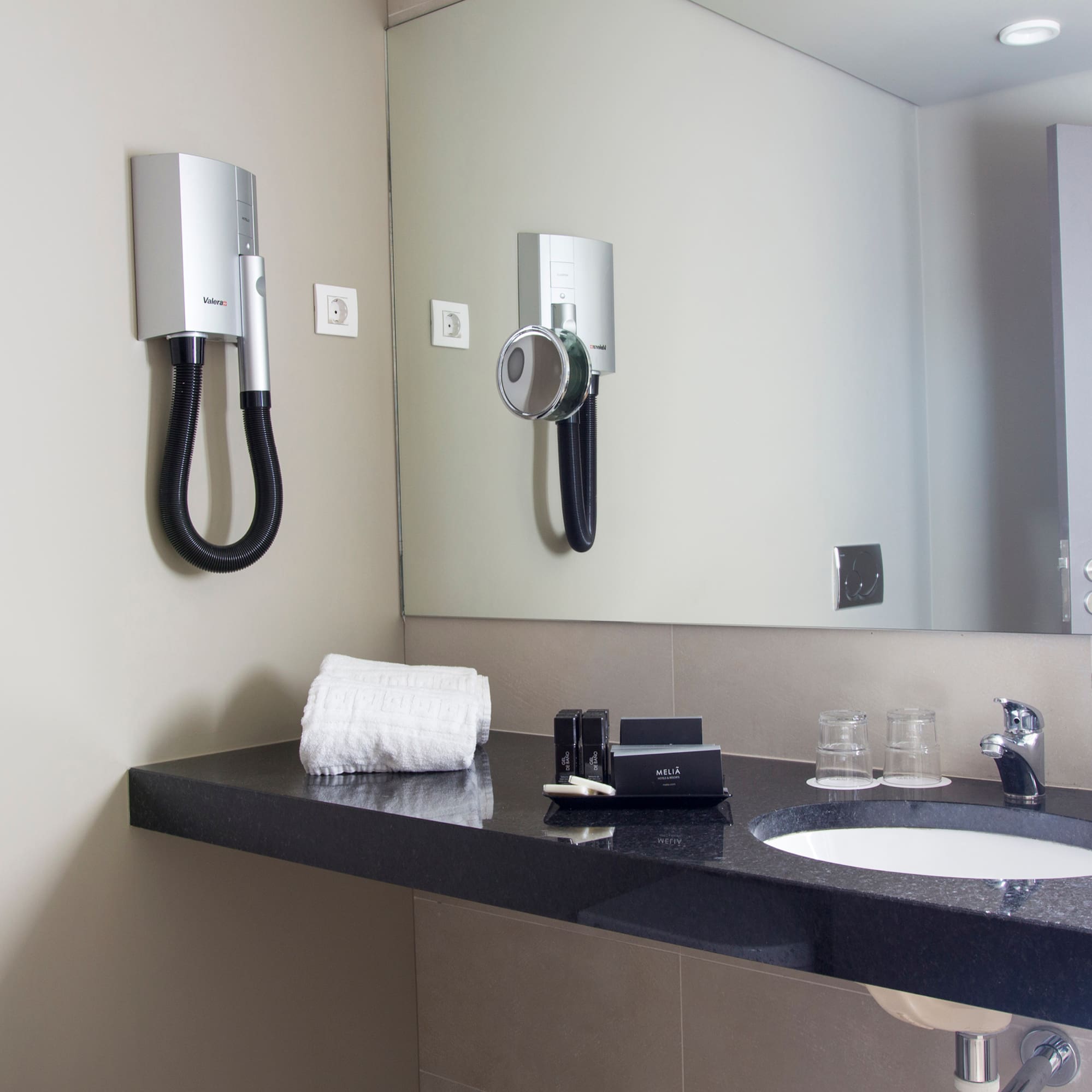 a bathroom with a mirror and a sink