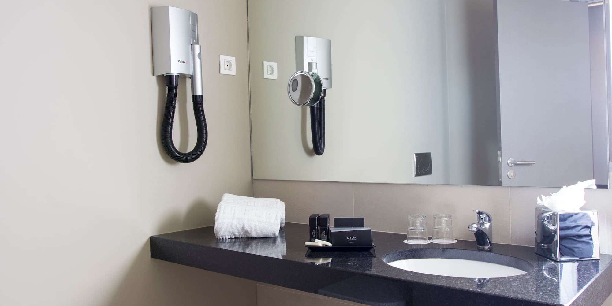 a bathroom with a mirror and a sink