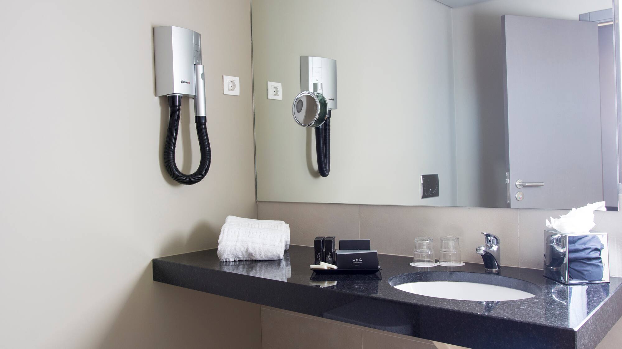 a bathroom with a mirror and a sink