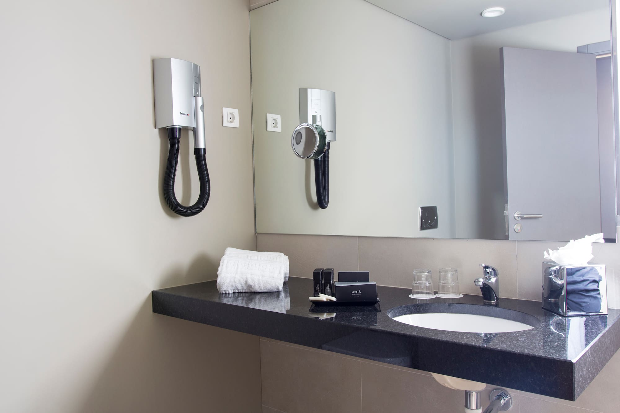 a bathroom with a mirror and a sink