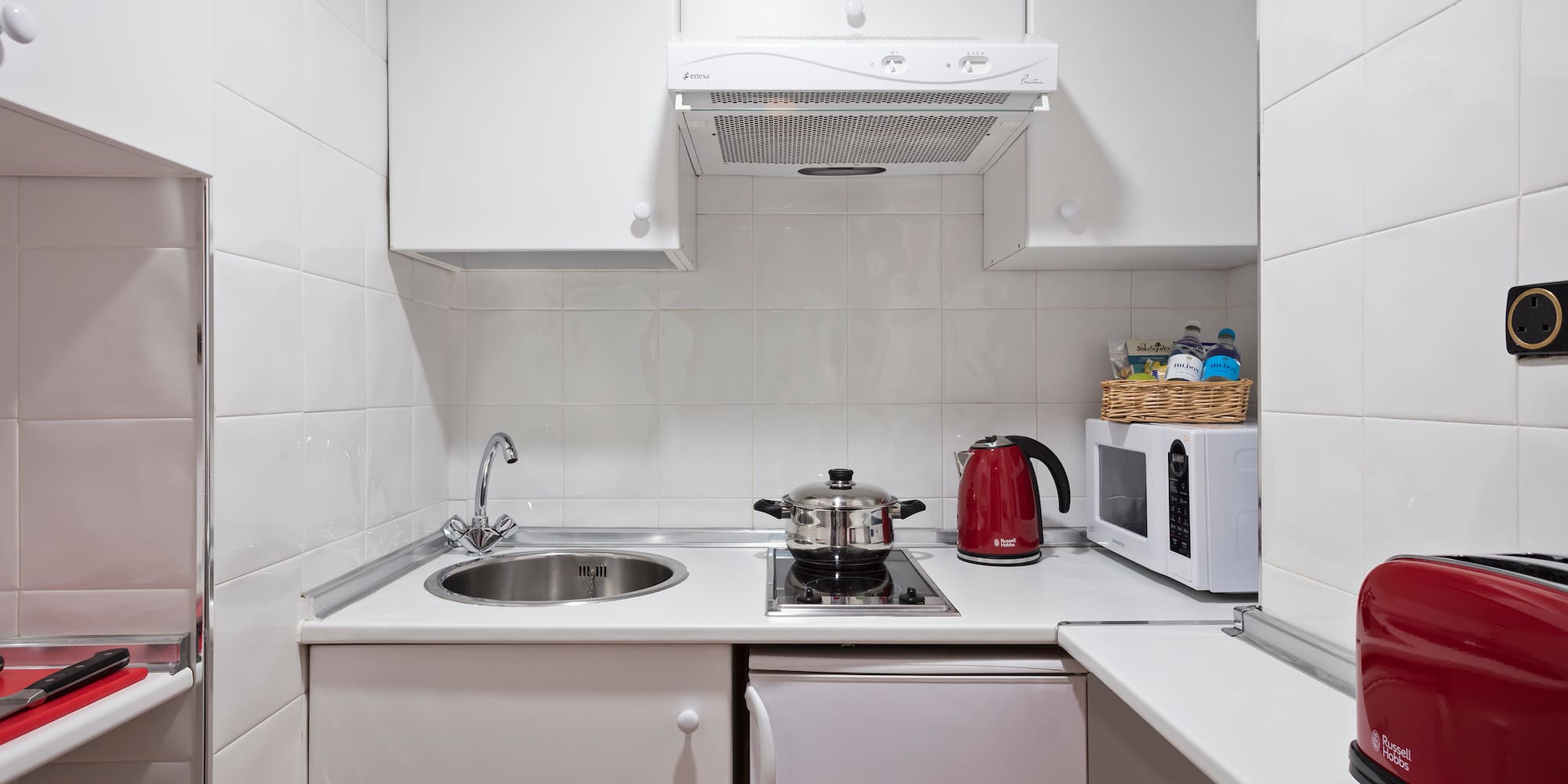 a kitchen with white cabinets and white appliances