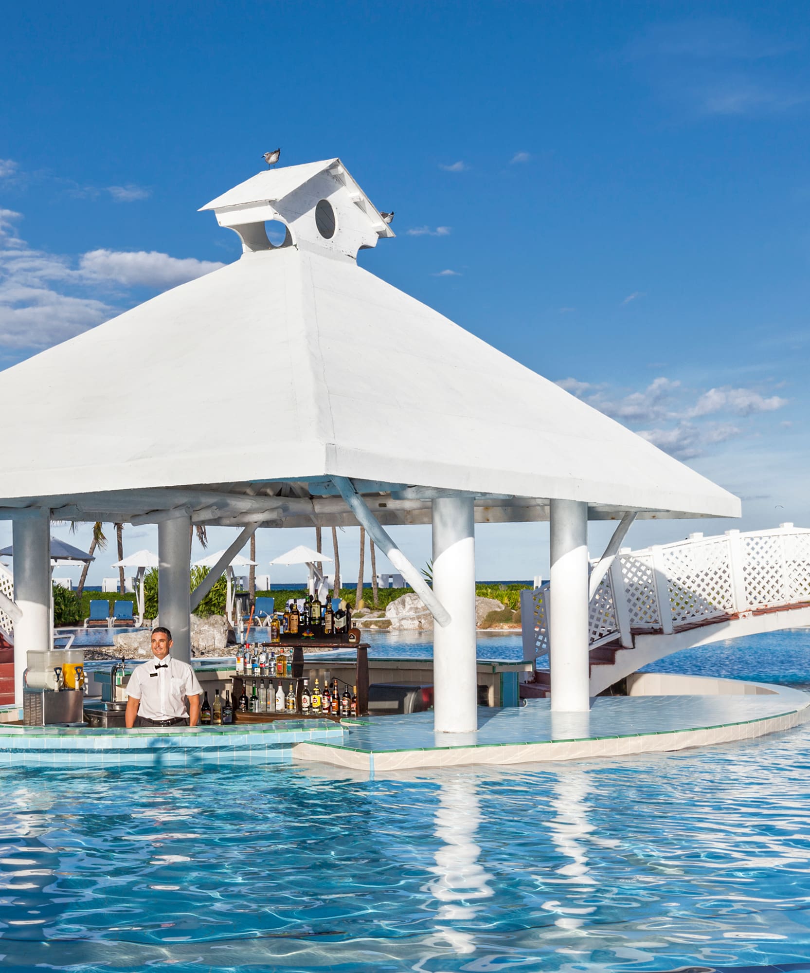 a man standing at a bar in a pool