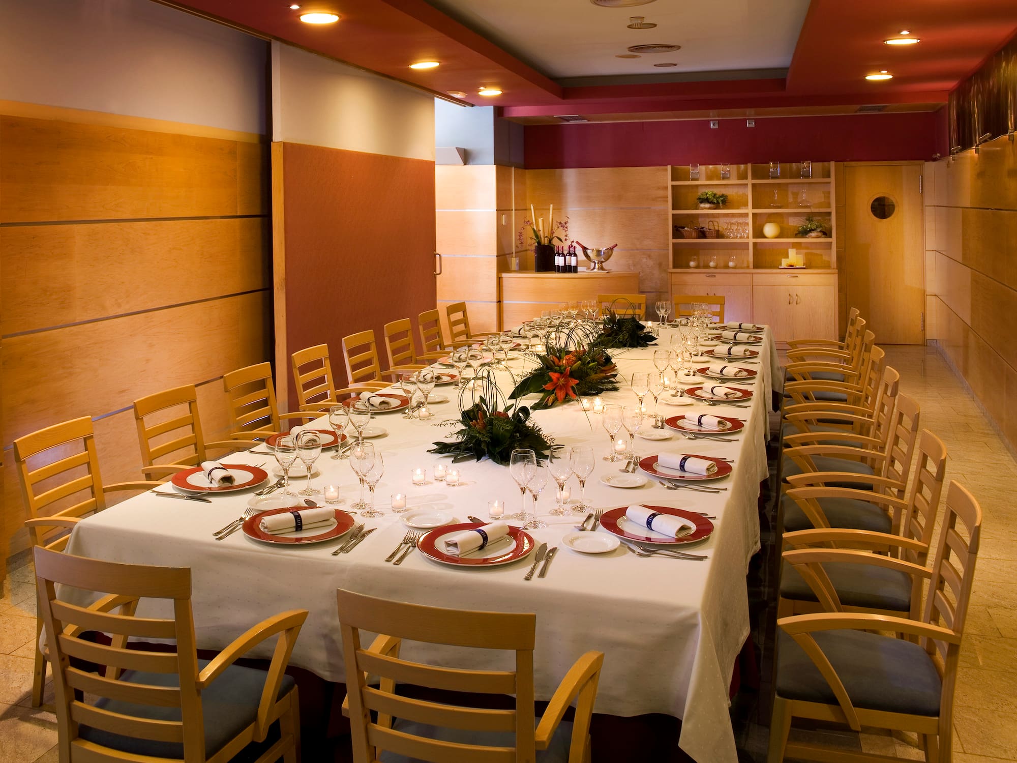 a long table with white tablecloths and plates