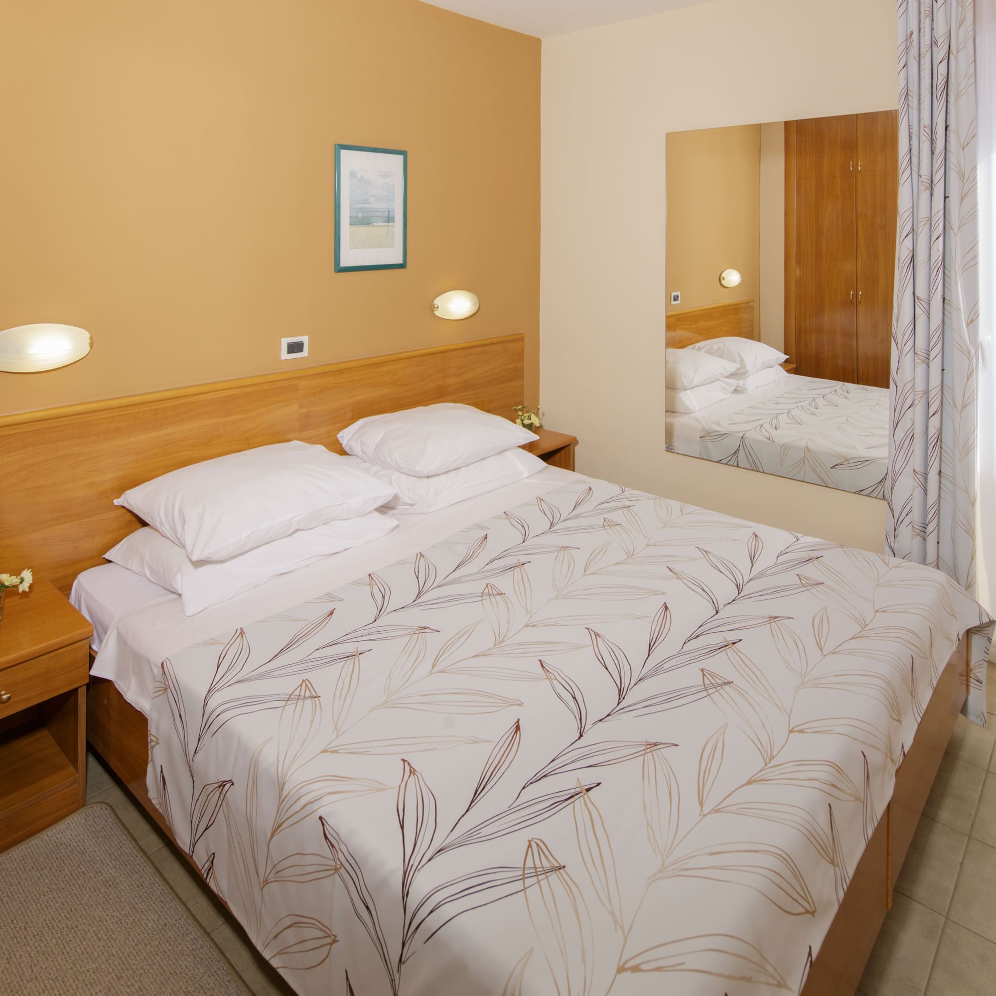 a bed with a mirror in a room