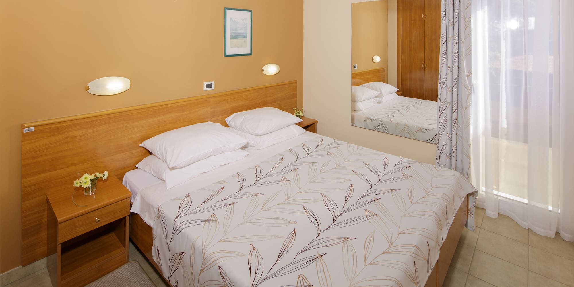 a bed with a mirror in a room