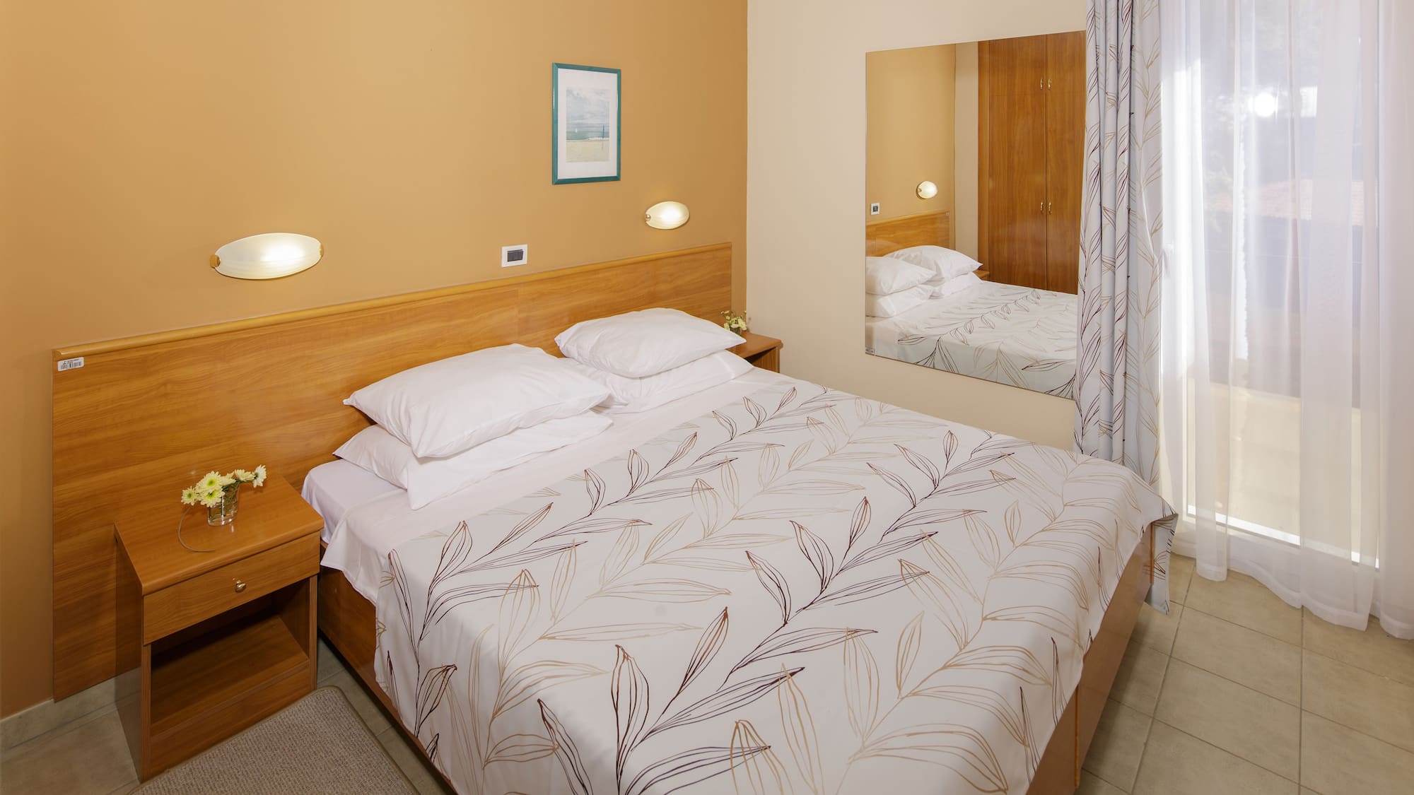 a bed with a mirror in a room