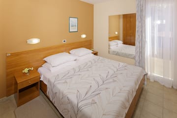 a bed with a mirror in a room