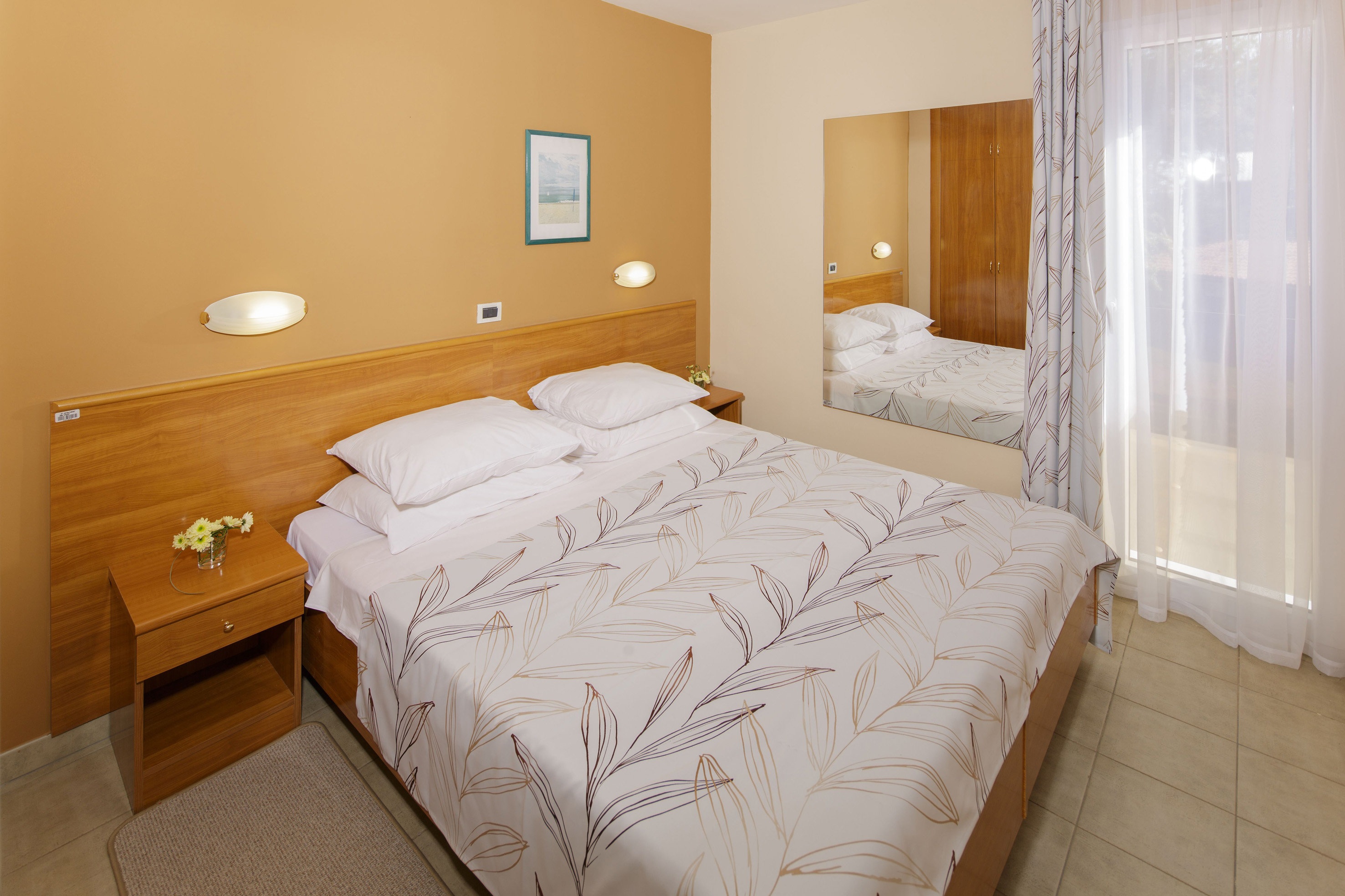 a bed with a mirror in a room