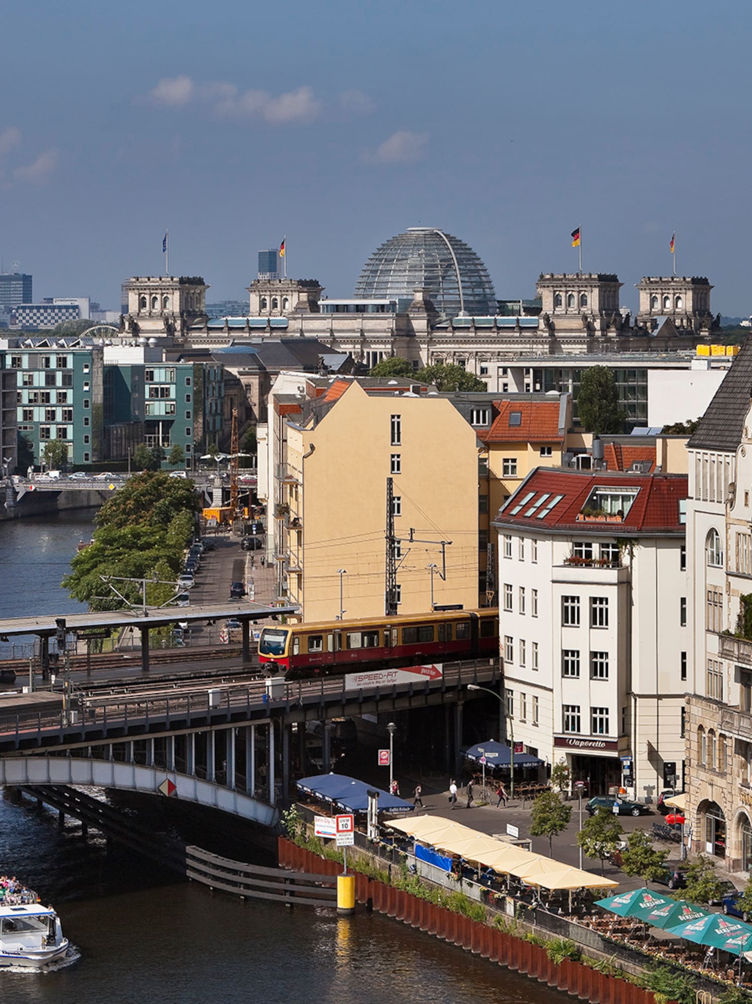 a bridge over a river with buildings and a boat