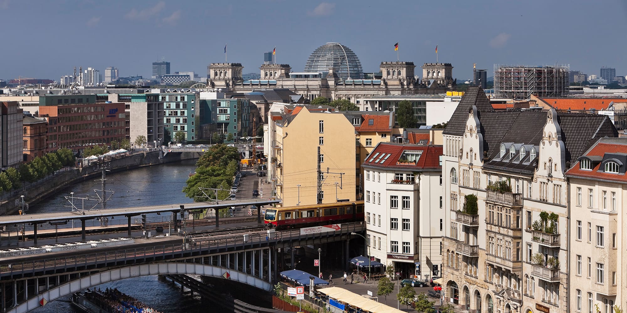 a bridge over a river with buildings and a boat