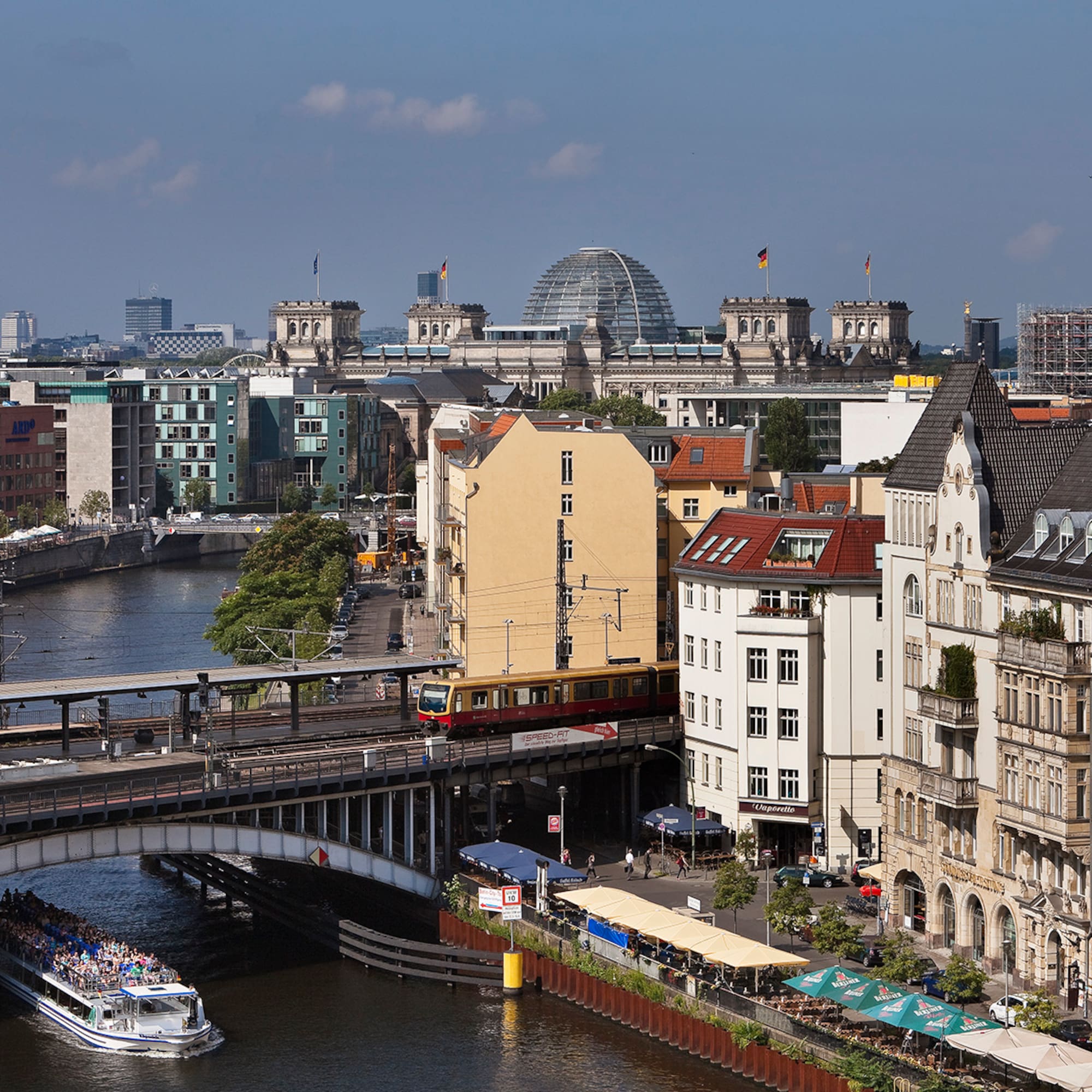 a bridge over a river with buildings and a boat