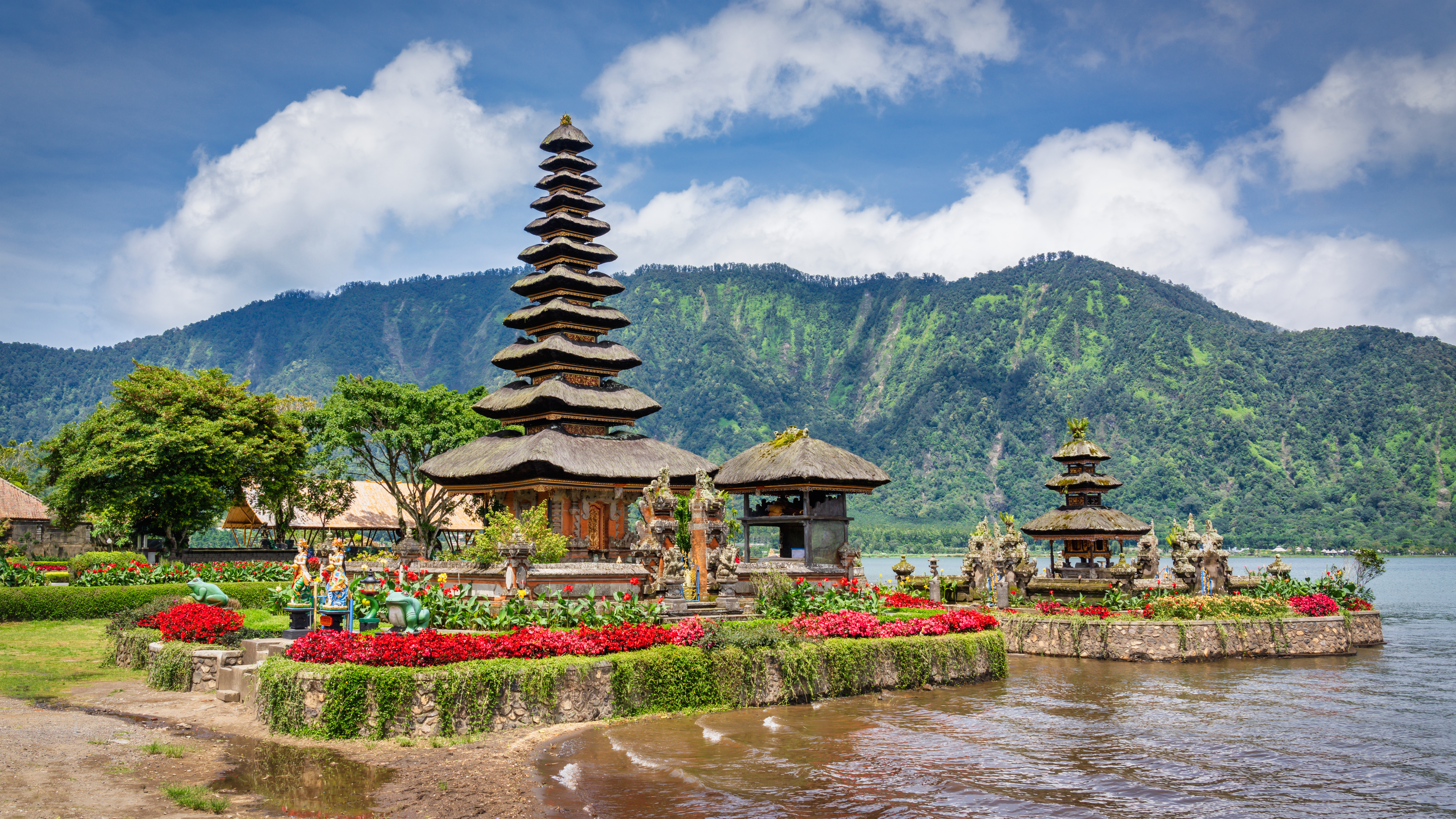 a lake with a pagoda and flowers