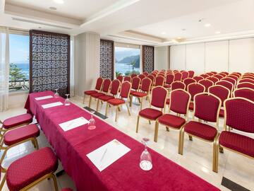 a room with red chairs and tables