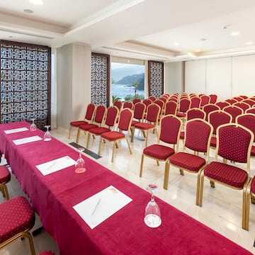 a room with red chairs and tables