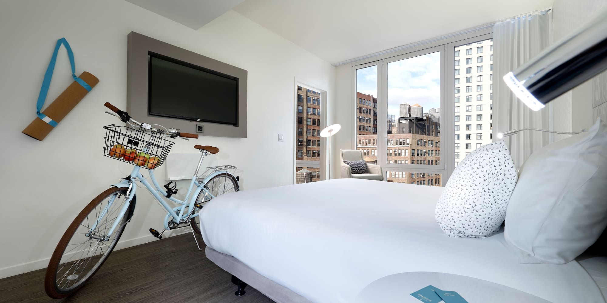 a bedroom with a bicycle and a television