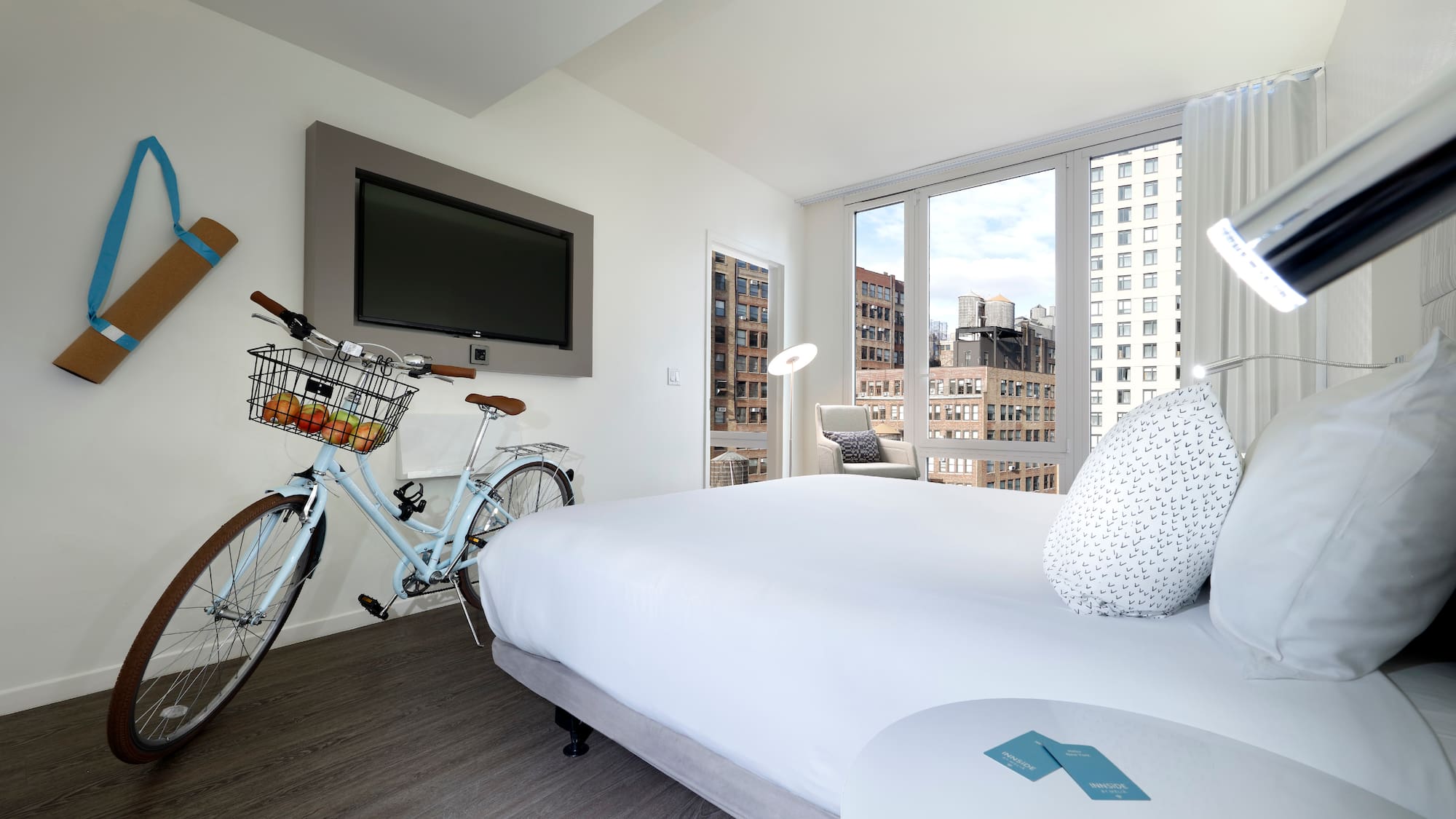 a bedroom with a bicycle and a television