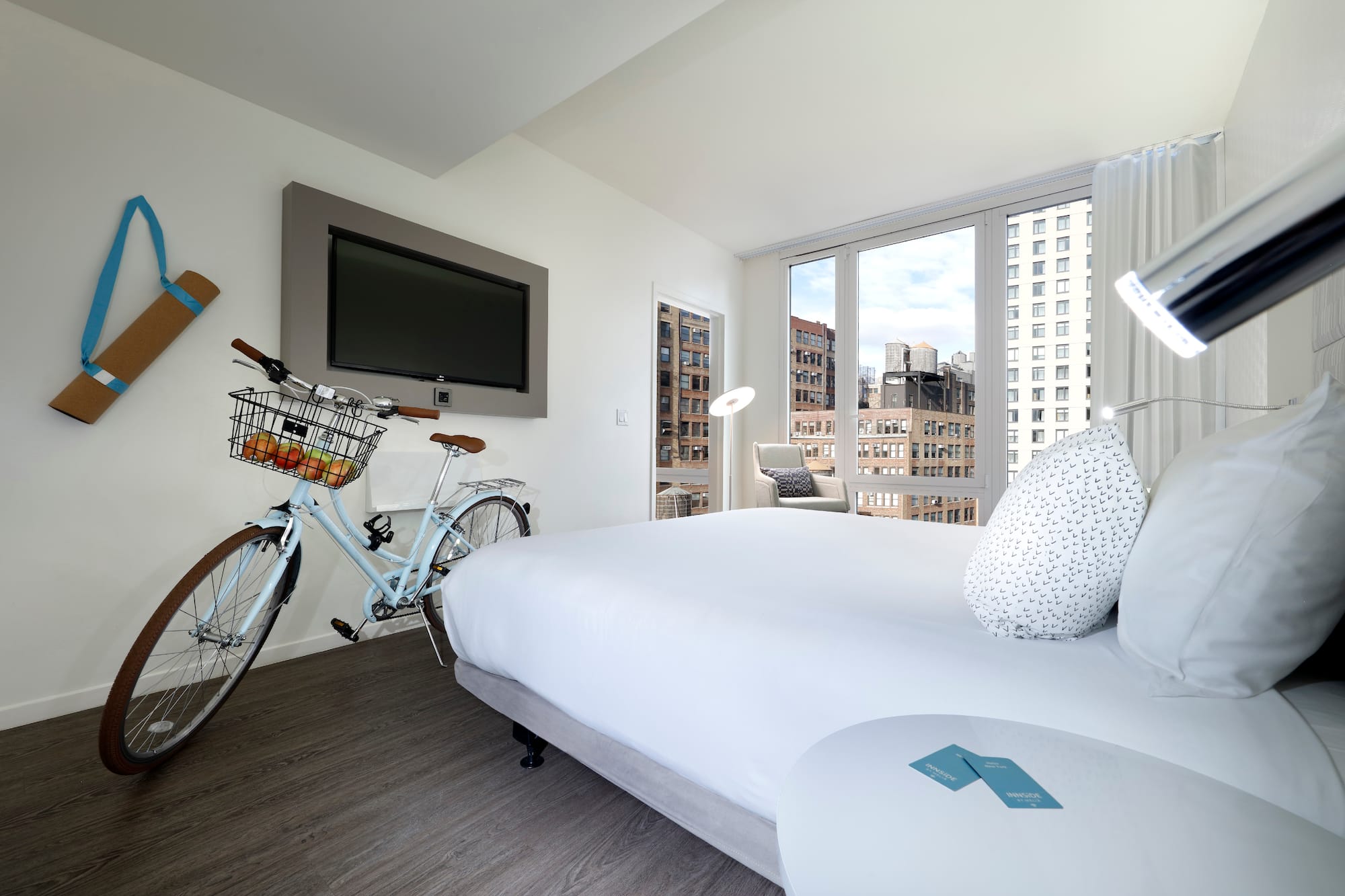 a bedroom with a bicycle and a television
