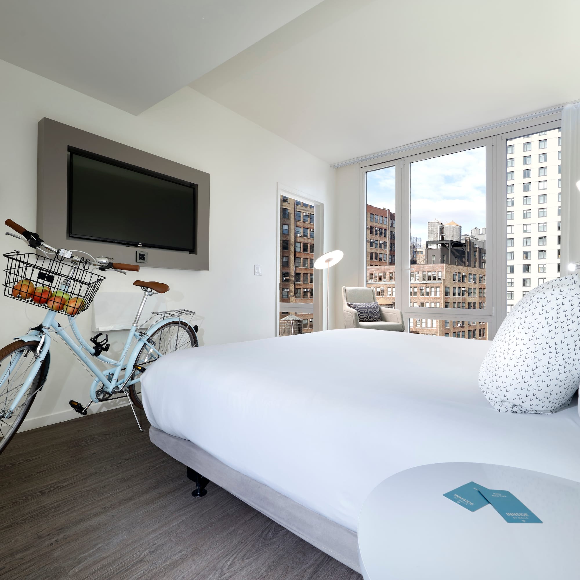 a bedroom with a bicycle and a television