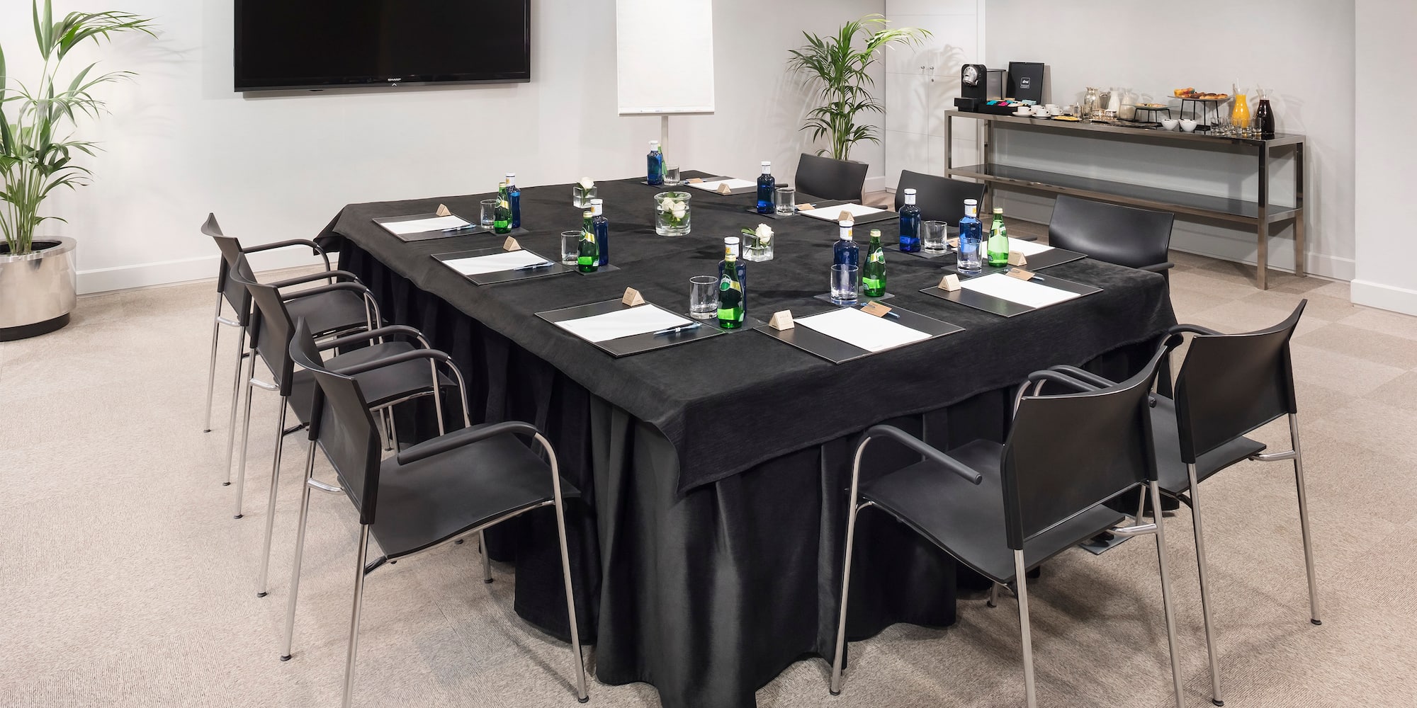 a table with black cloth and chairs