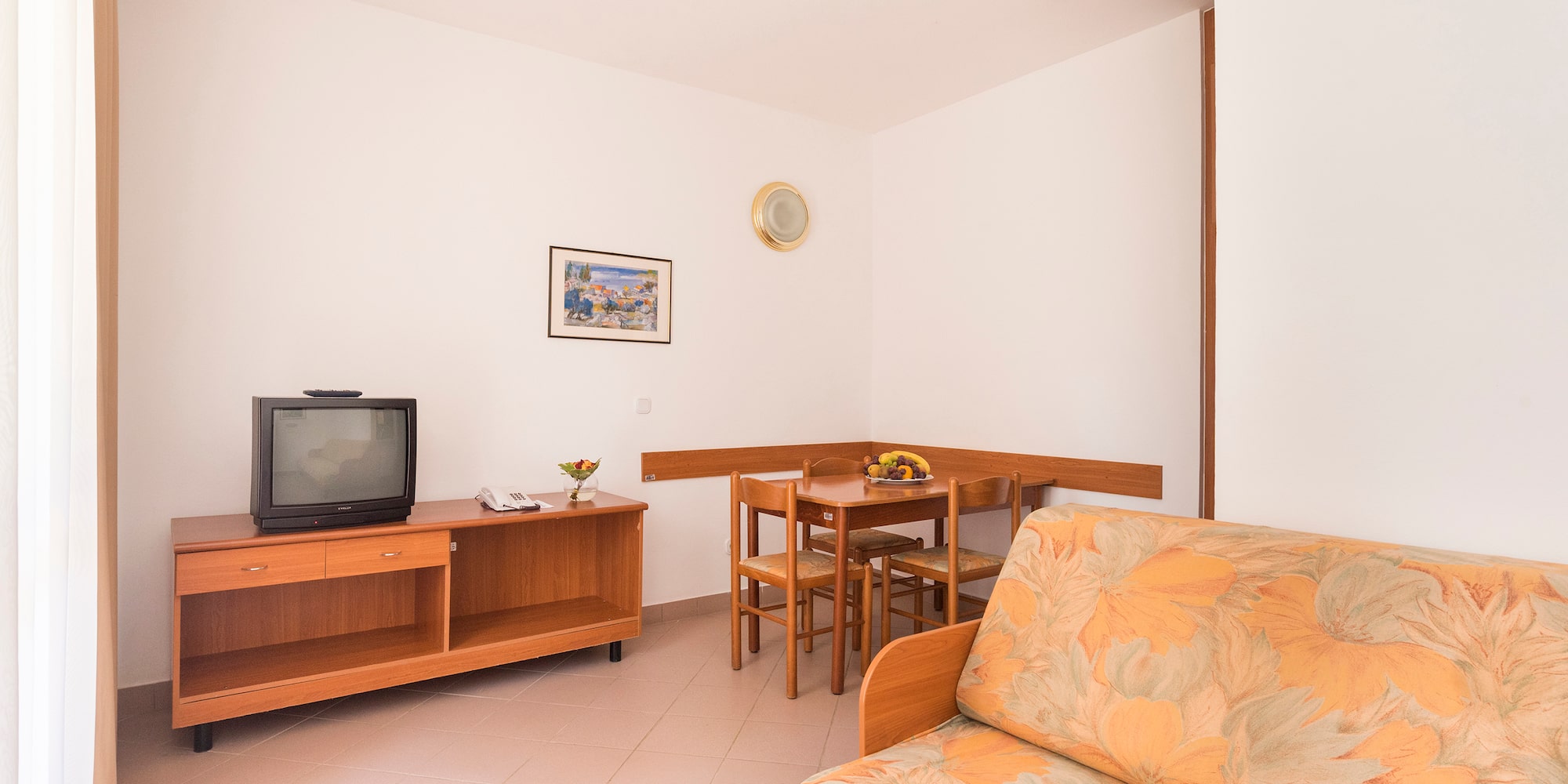 a living room with a couch and a table and tv