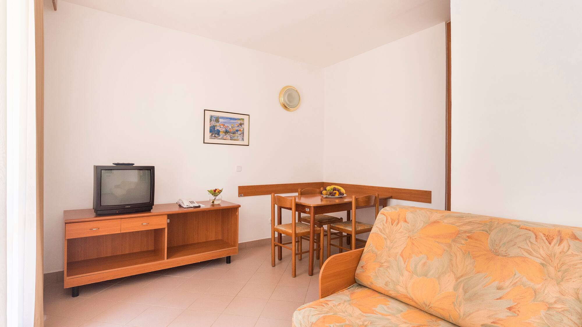 a living room with a couch and a table and tv