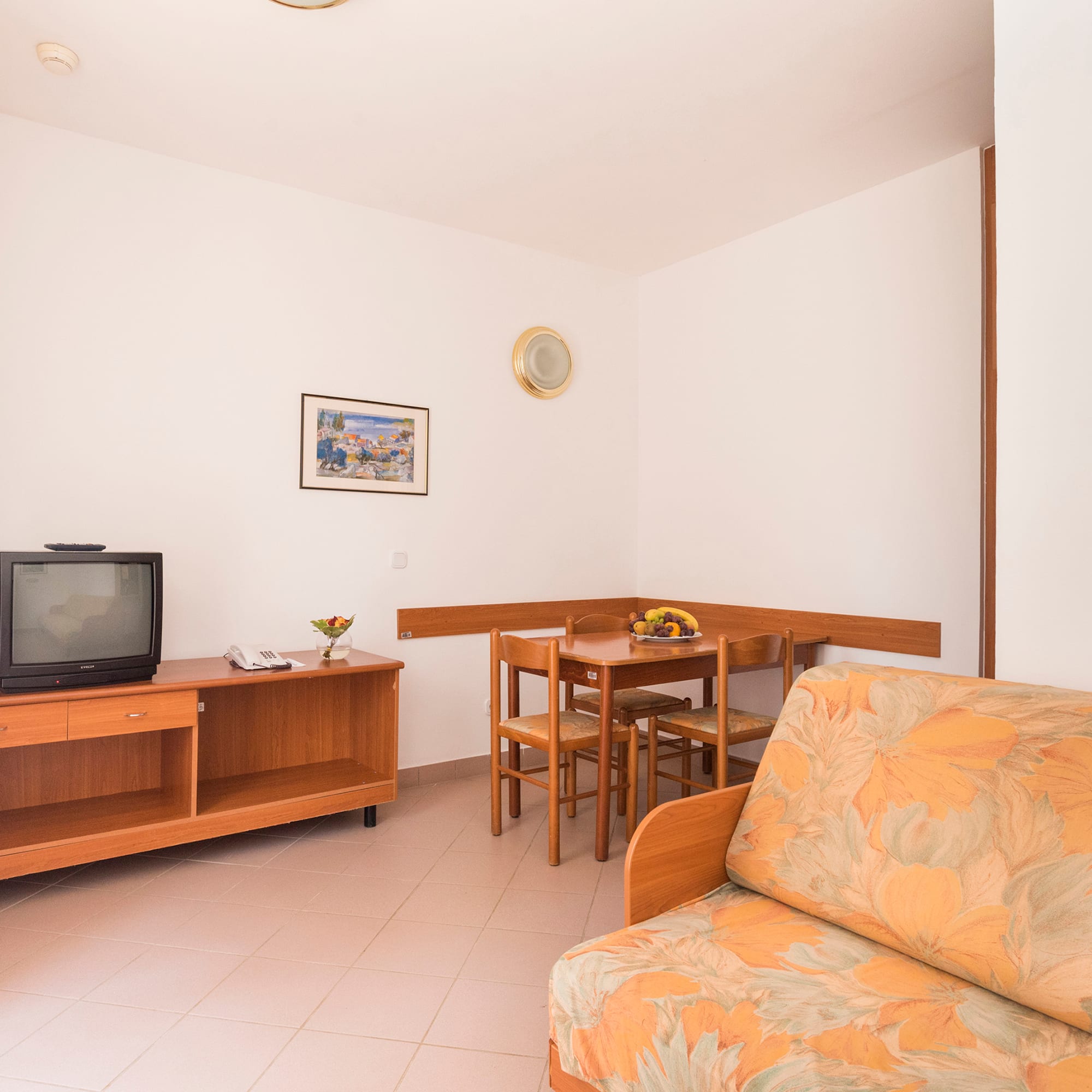 a living room with a couch and a table and tv