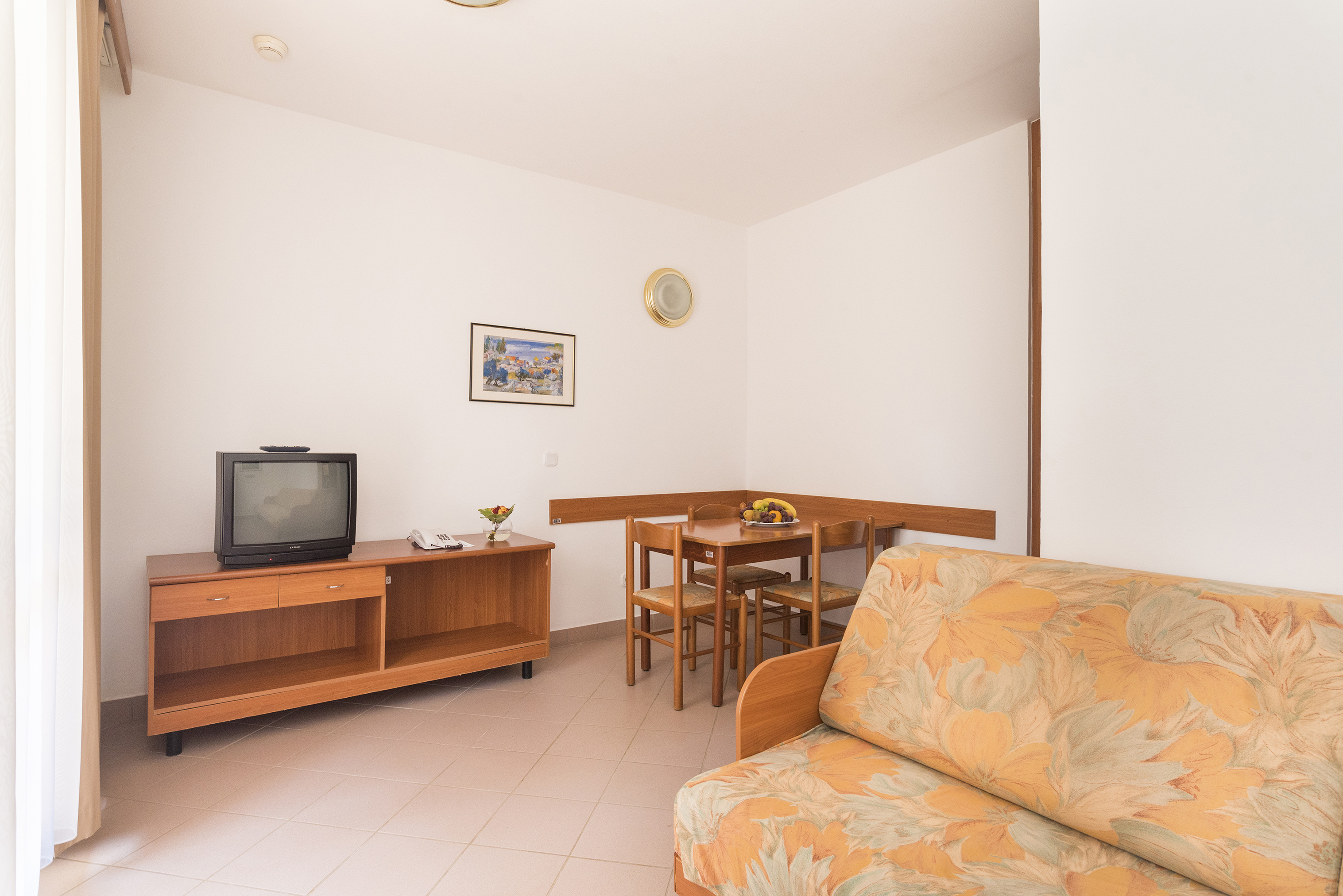 a living room with a couch and a table and tv