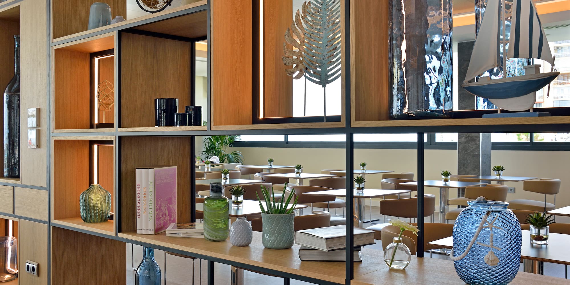 a shelf with books and vases on it