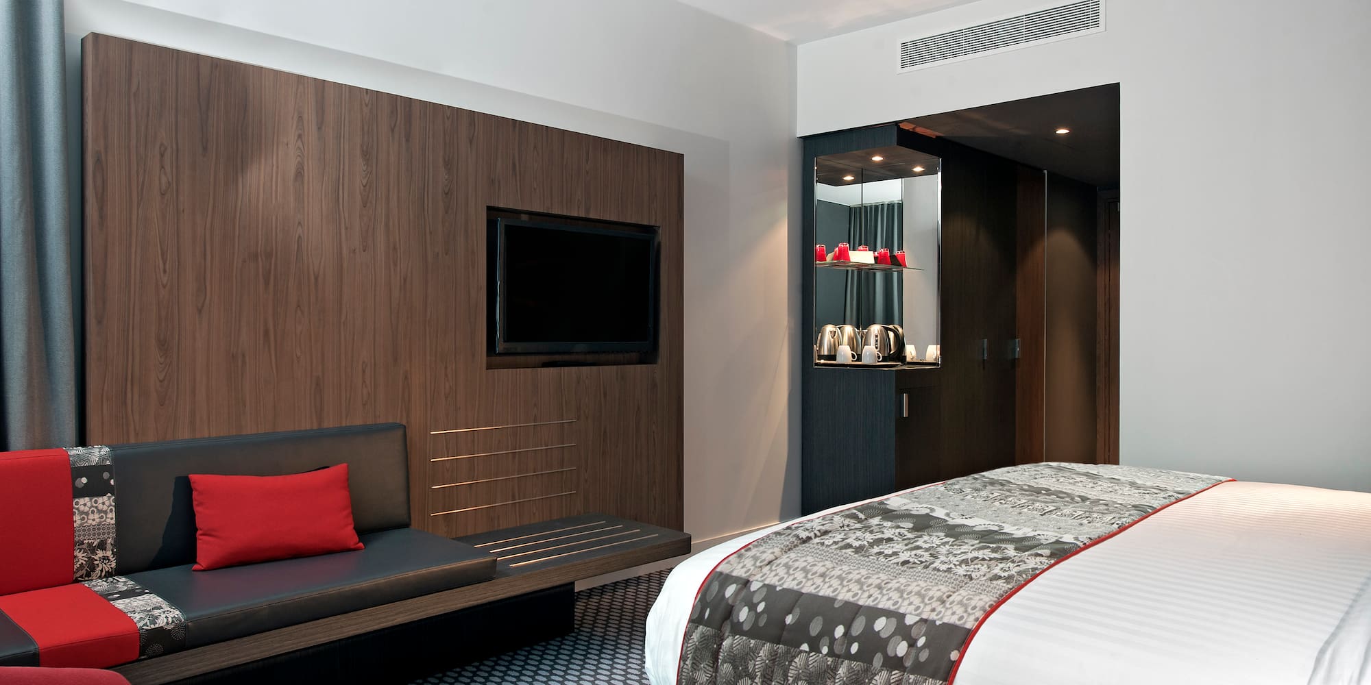 a room with a bed and a tv