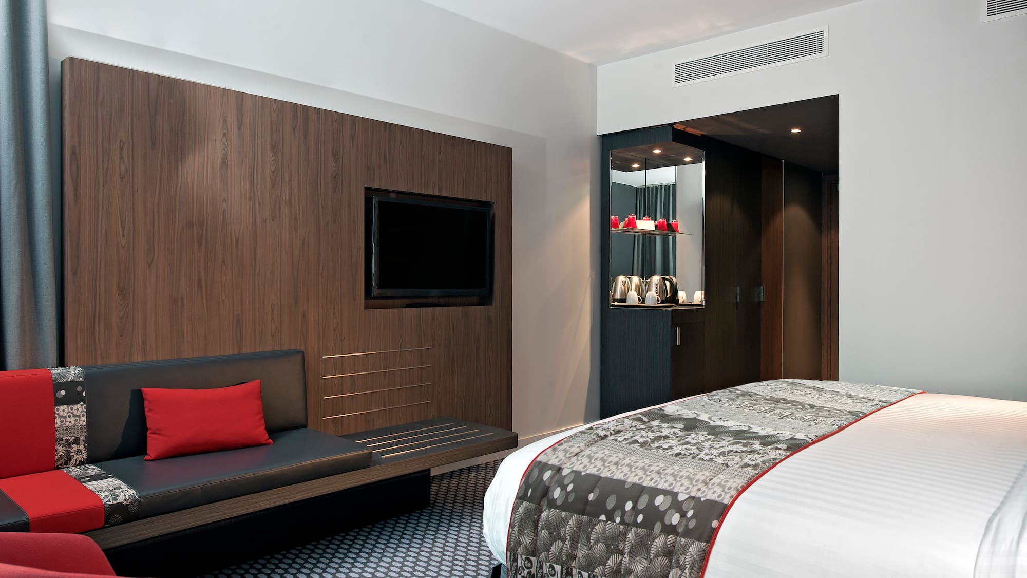 a room with a bed and a tv