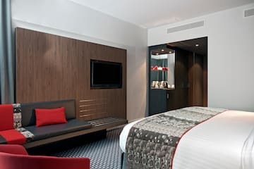 a room with a bed and a tv