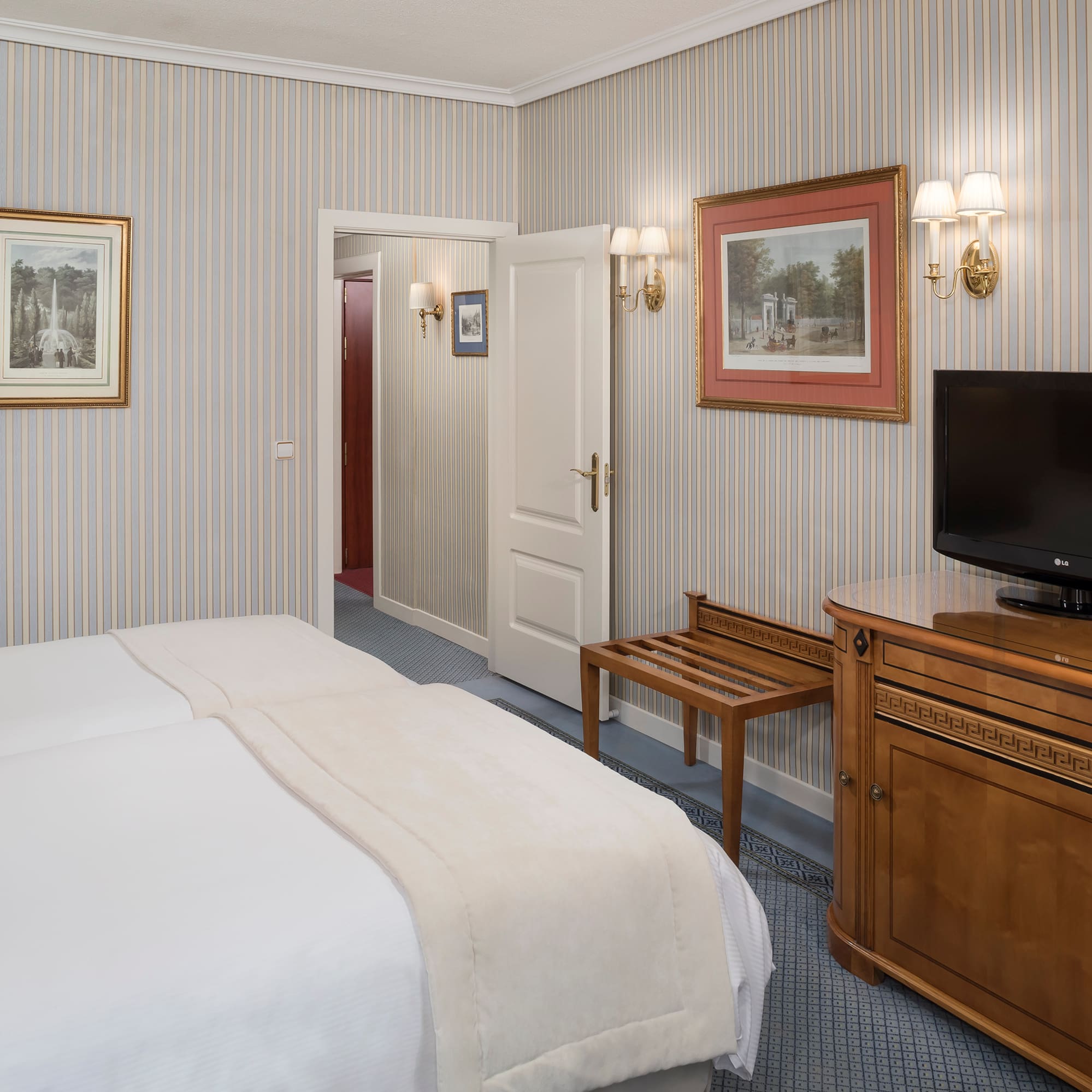 a room with a bed and a television