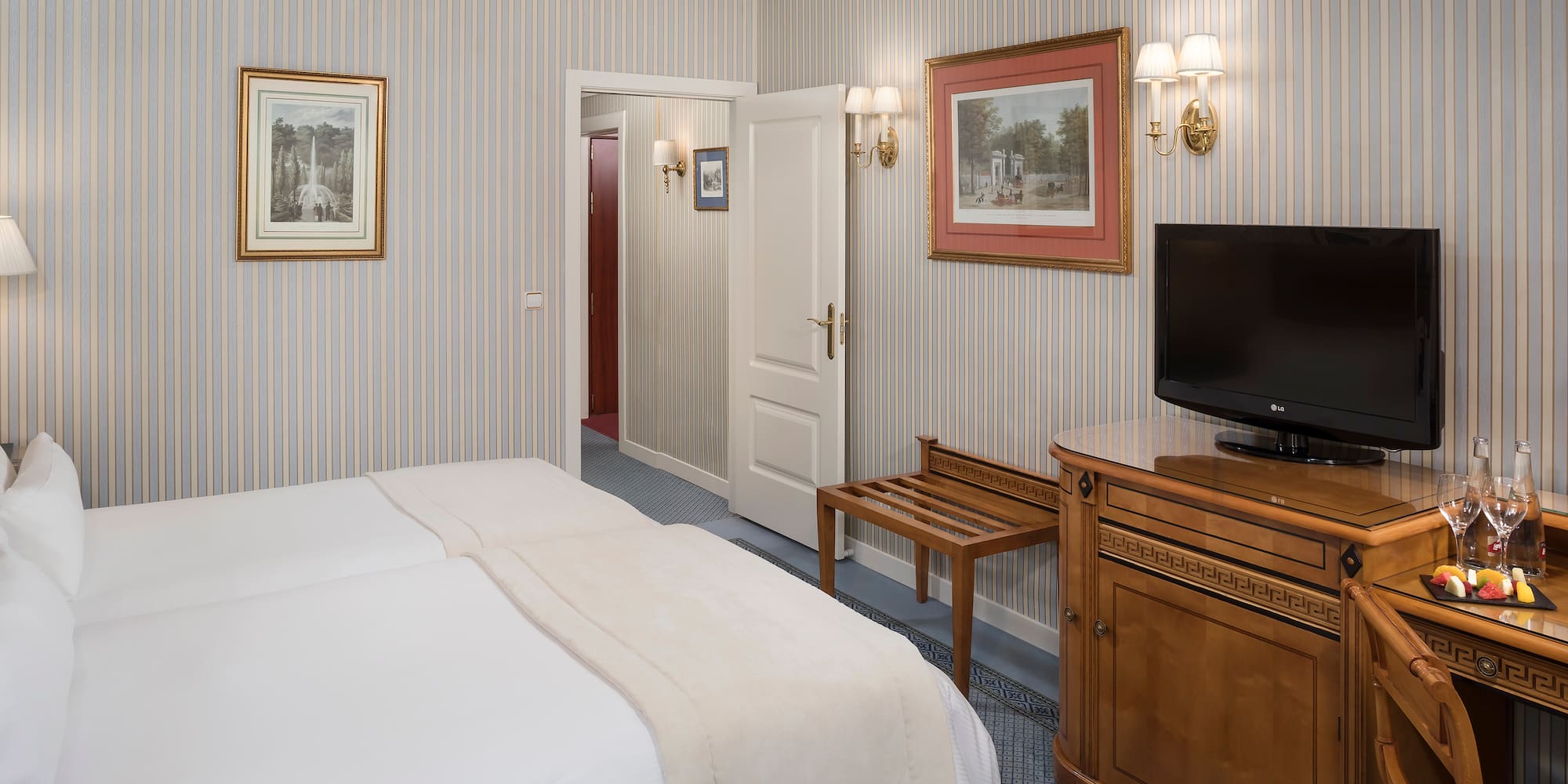 a room with a bed and a television