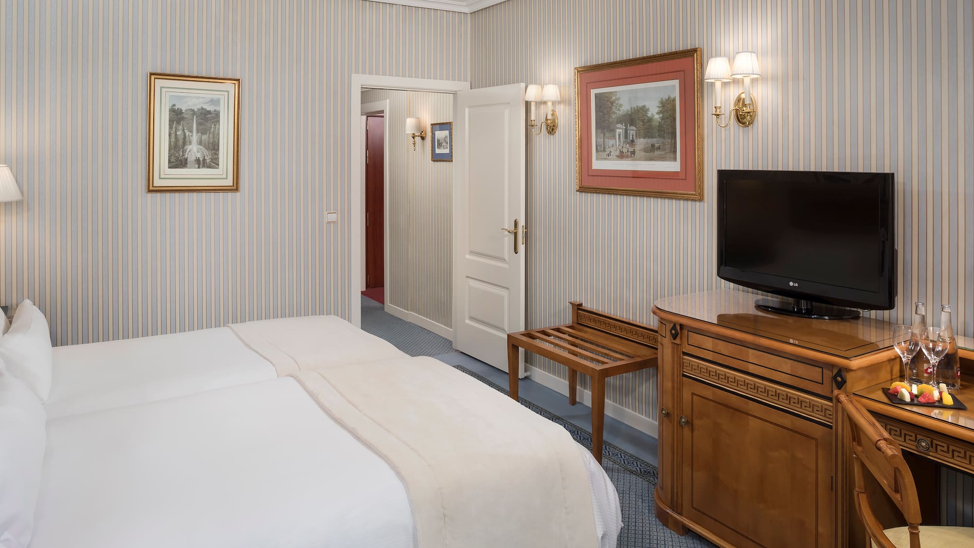 a room with a bed and a television