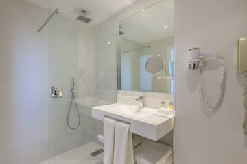a bathroom with a shower and sink