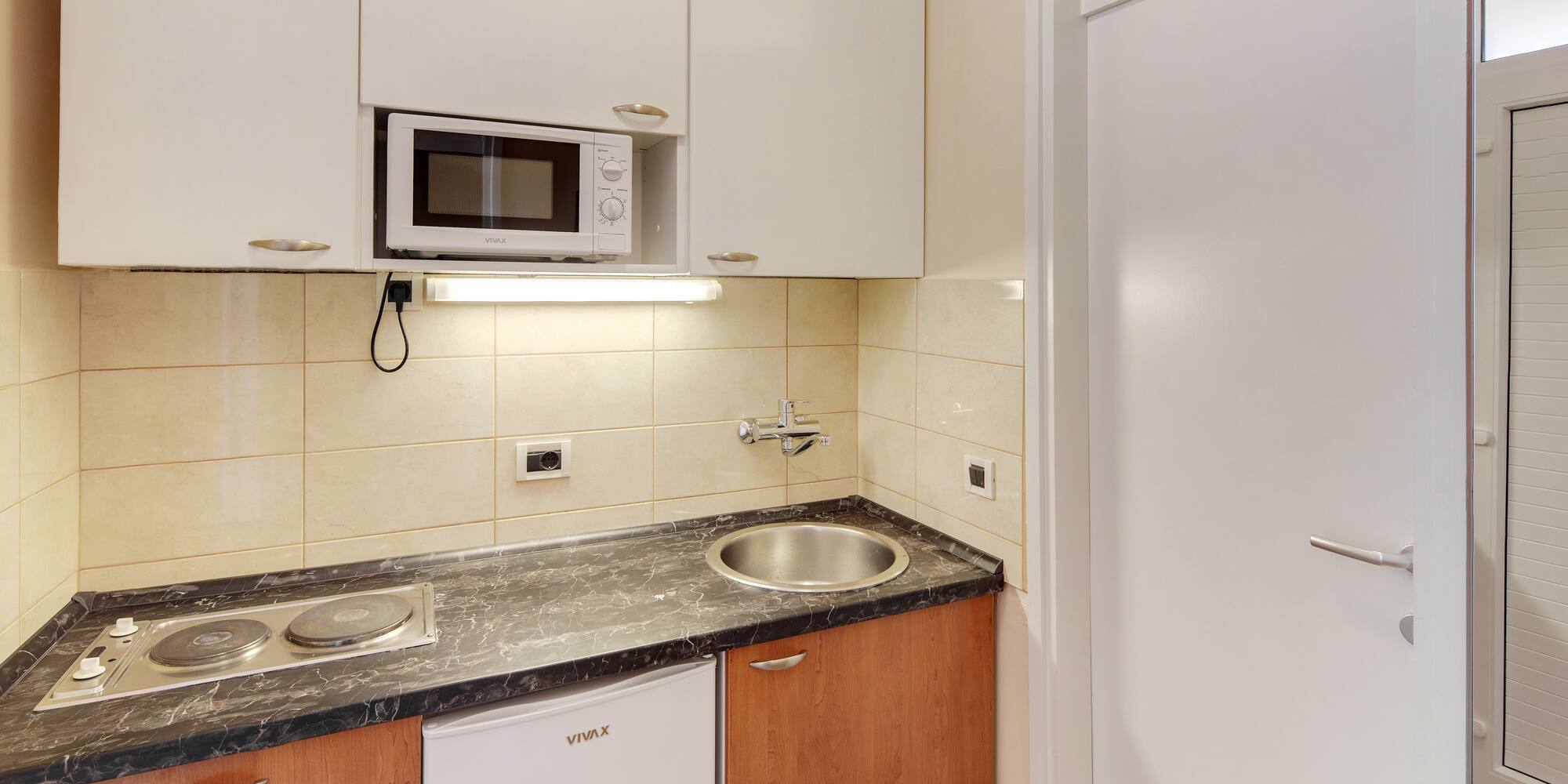 a kitchen with white cabinets and a microwave