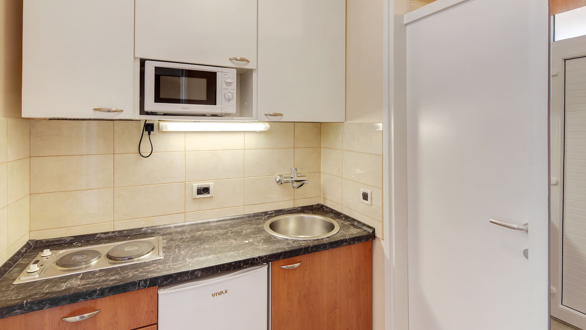 a kitchen with white cabinets and a microwave